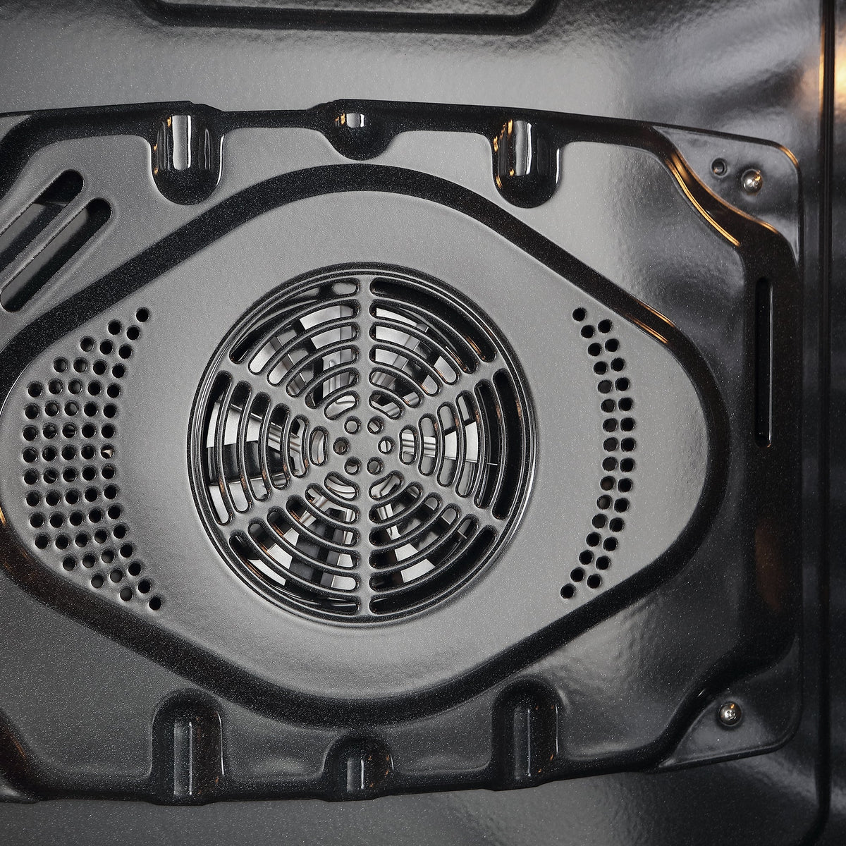 Oven cavity fan and vent with circular grill and perforated side openings