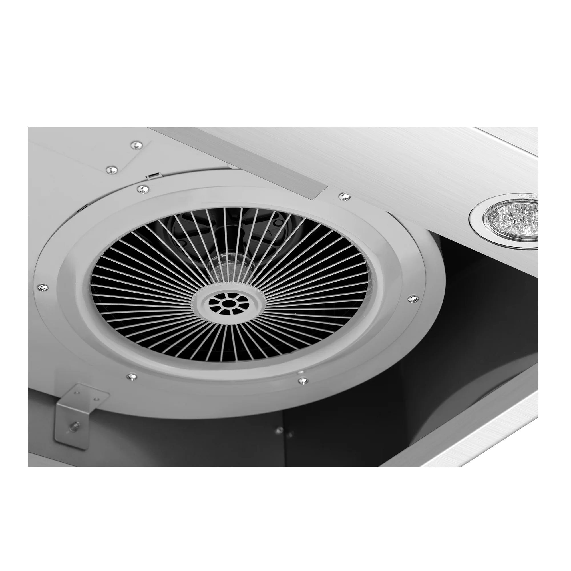 Close-up of circular blower intake with radial grille inside the range hood