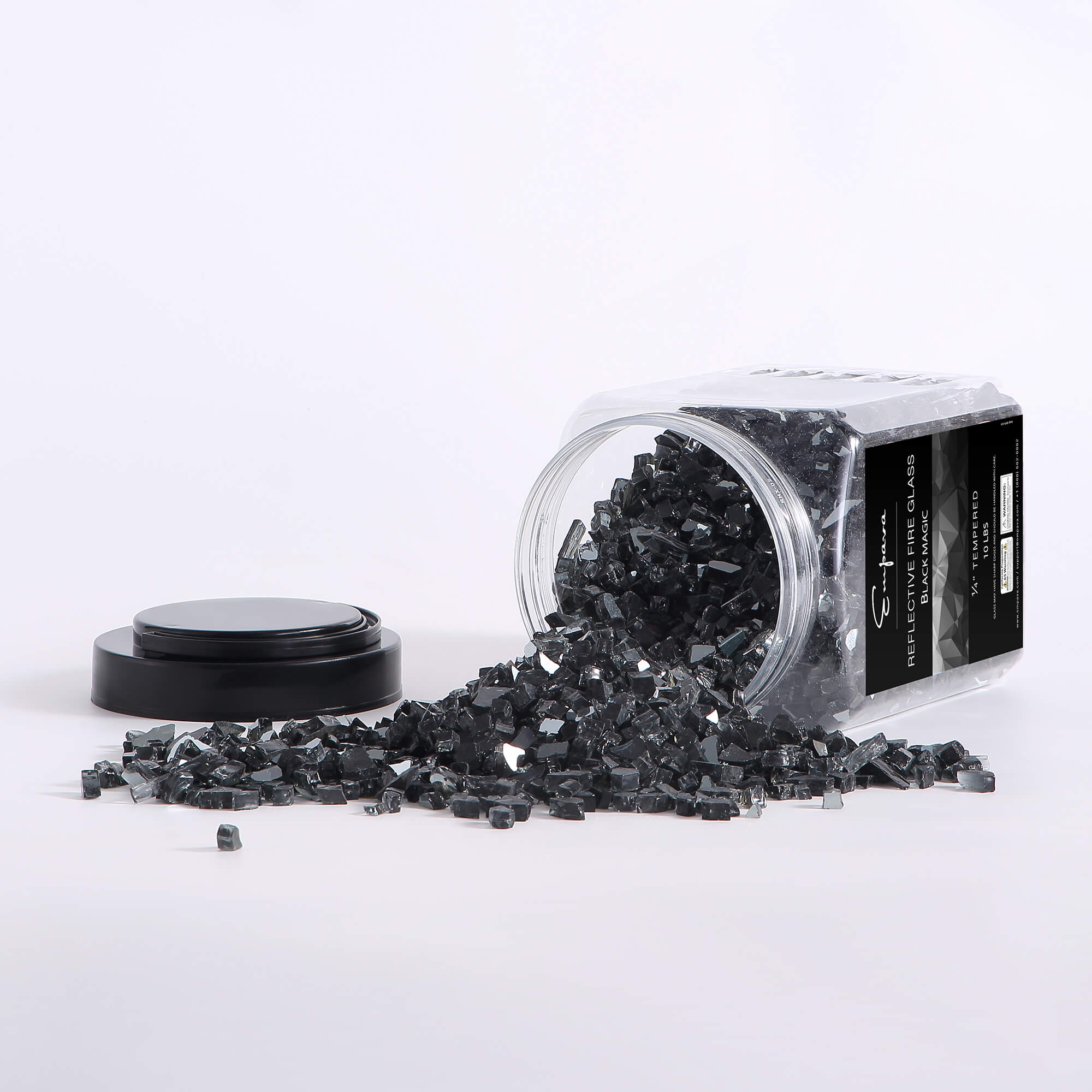 Reflective tempered fire glass in black, with glass shards spilled on a surface
