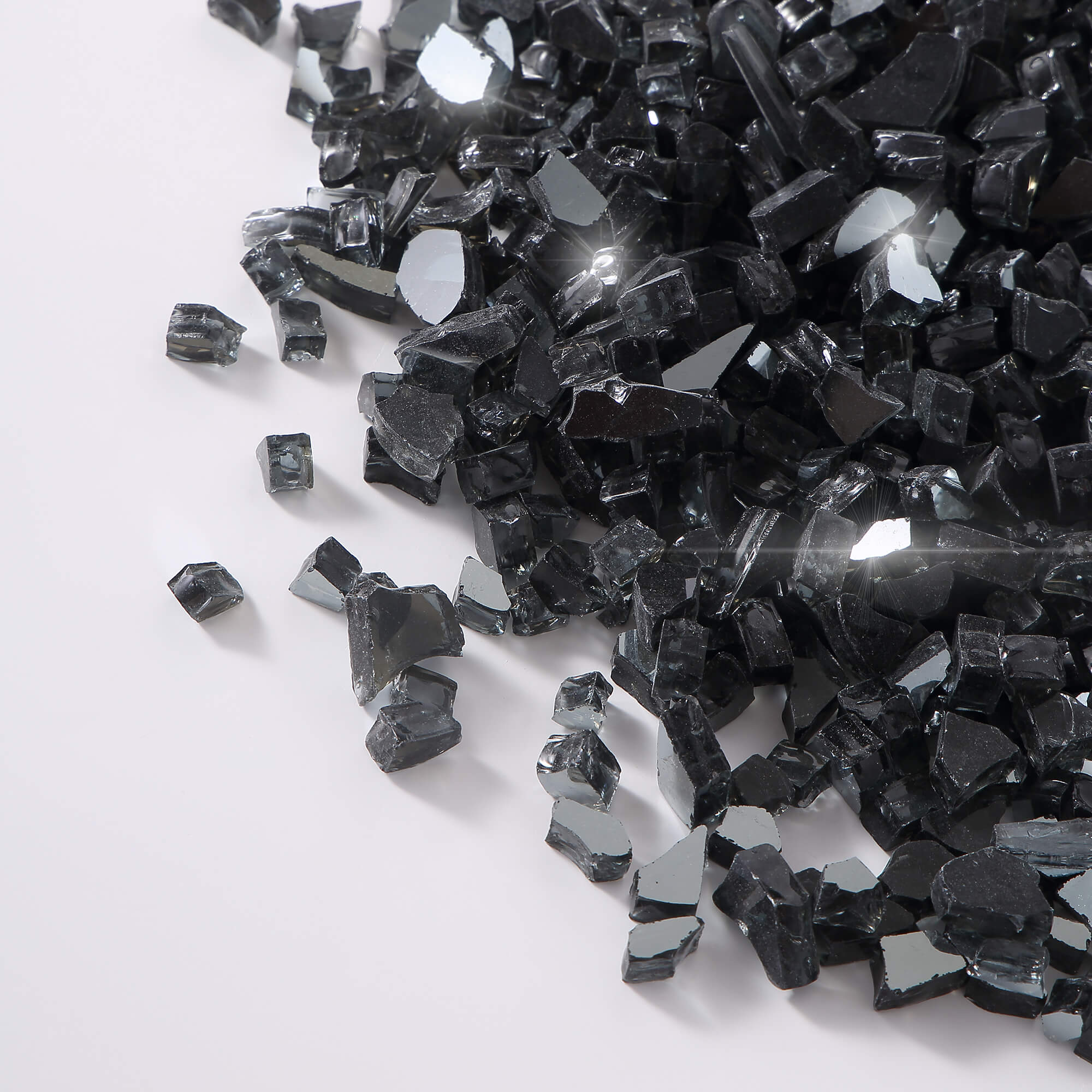 Close-up of black tempered fire glass chunks with reflective facets