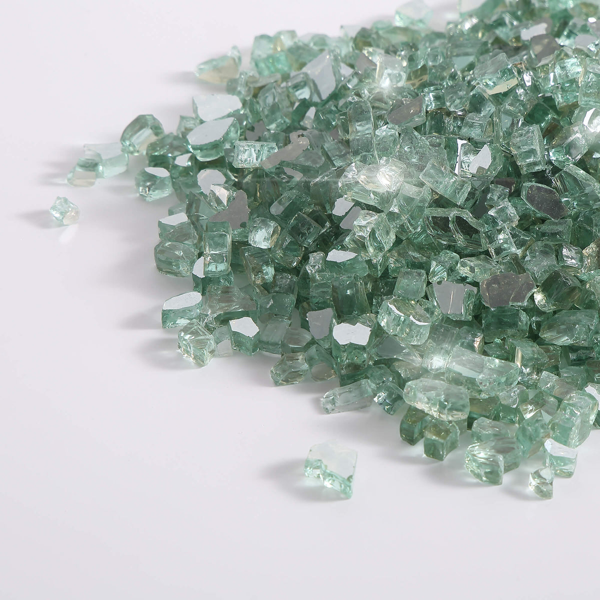 Radiant jade green tempered reflective fire glass chunks, scattered on a surface.