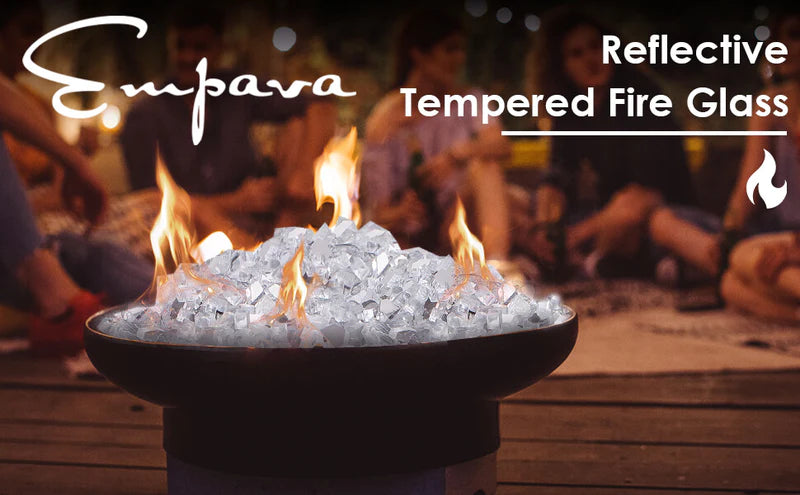 Reflective tempered fire glass chunks with open flames in a fire pit