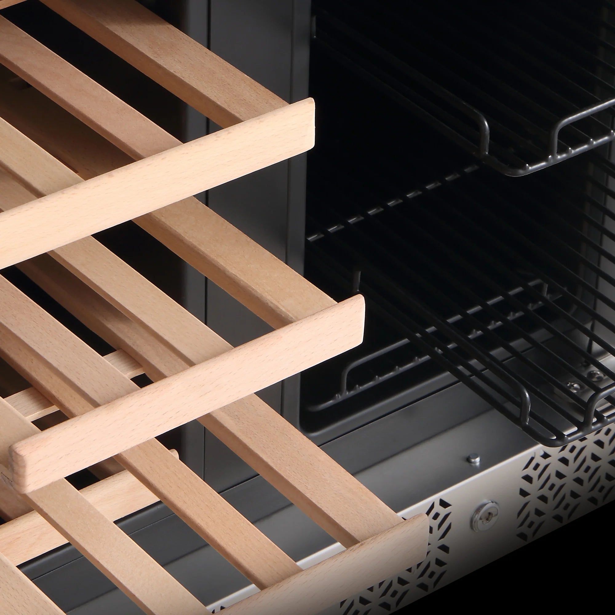 Close-up of light wood bottle rack slats inside a stainless wine cooler