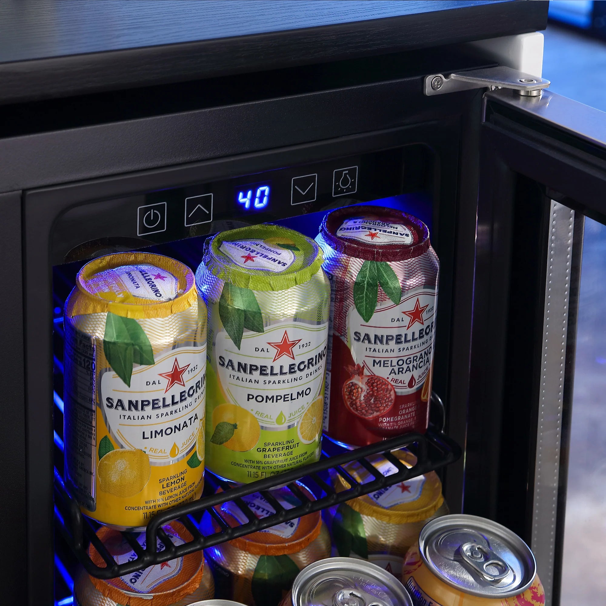 Dual-zone wine and beverage cooler, glass door open showing cans on interior shelves