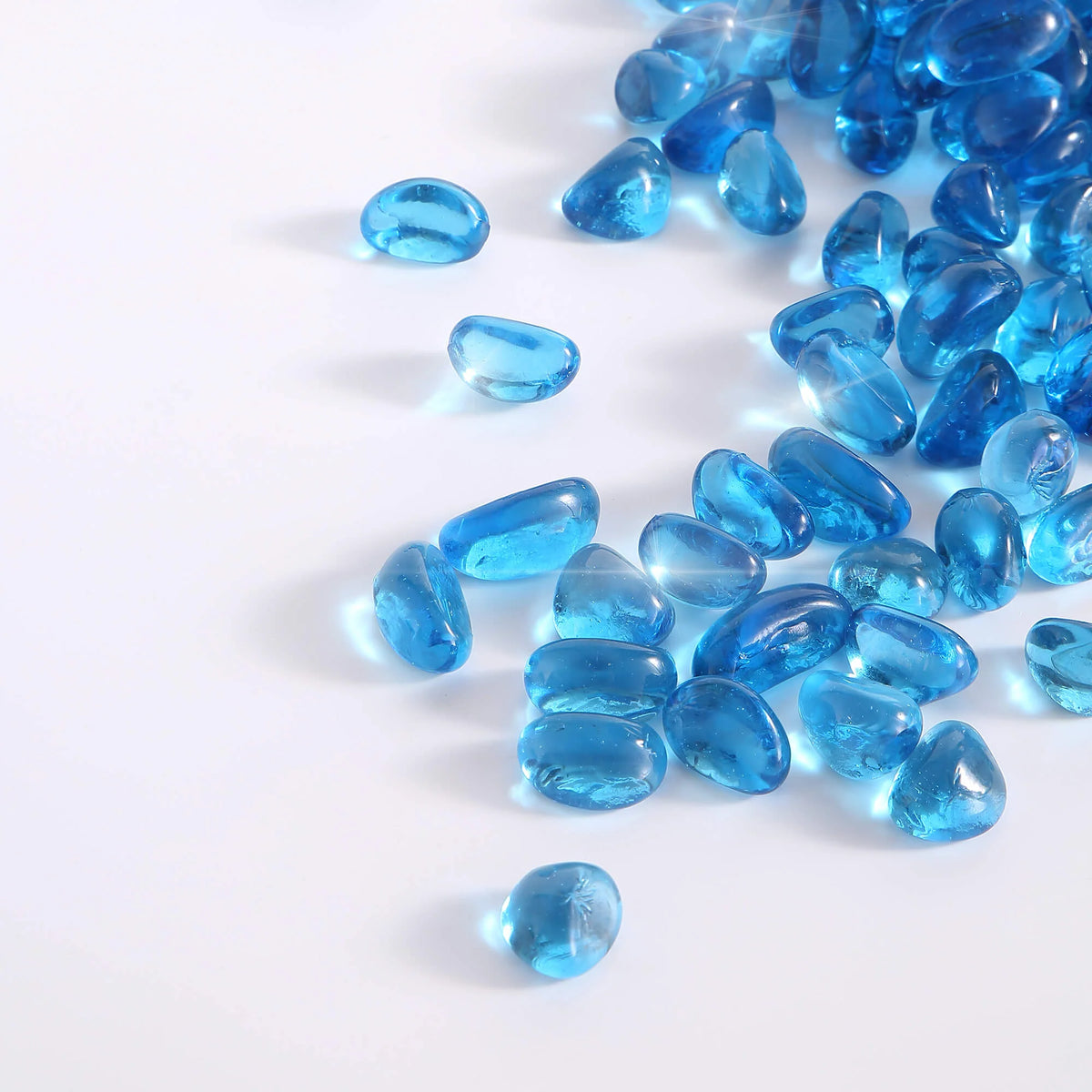Caribbean blue tempered fire glass cashew-shaped pieces, glossy reflective finish
