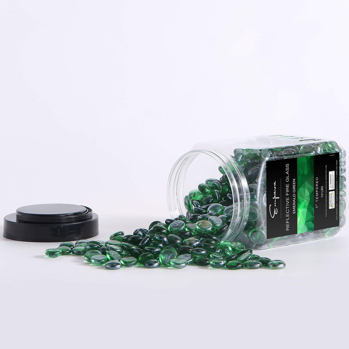 Green reflective tempered fire glass beads scattered beside clear jar