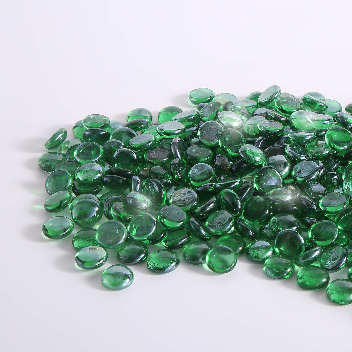 Green tempered fire glass beads, round reflective pieces in a pile