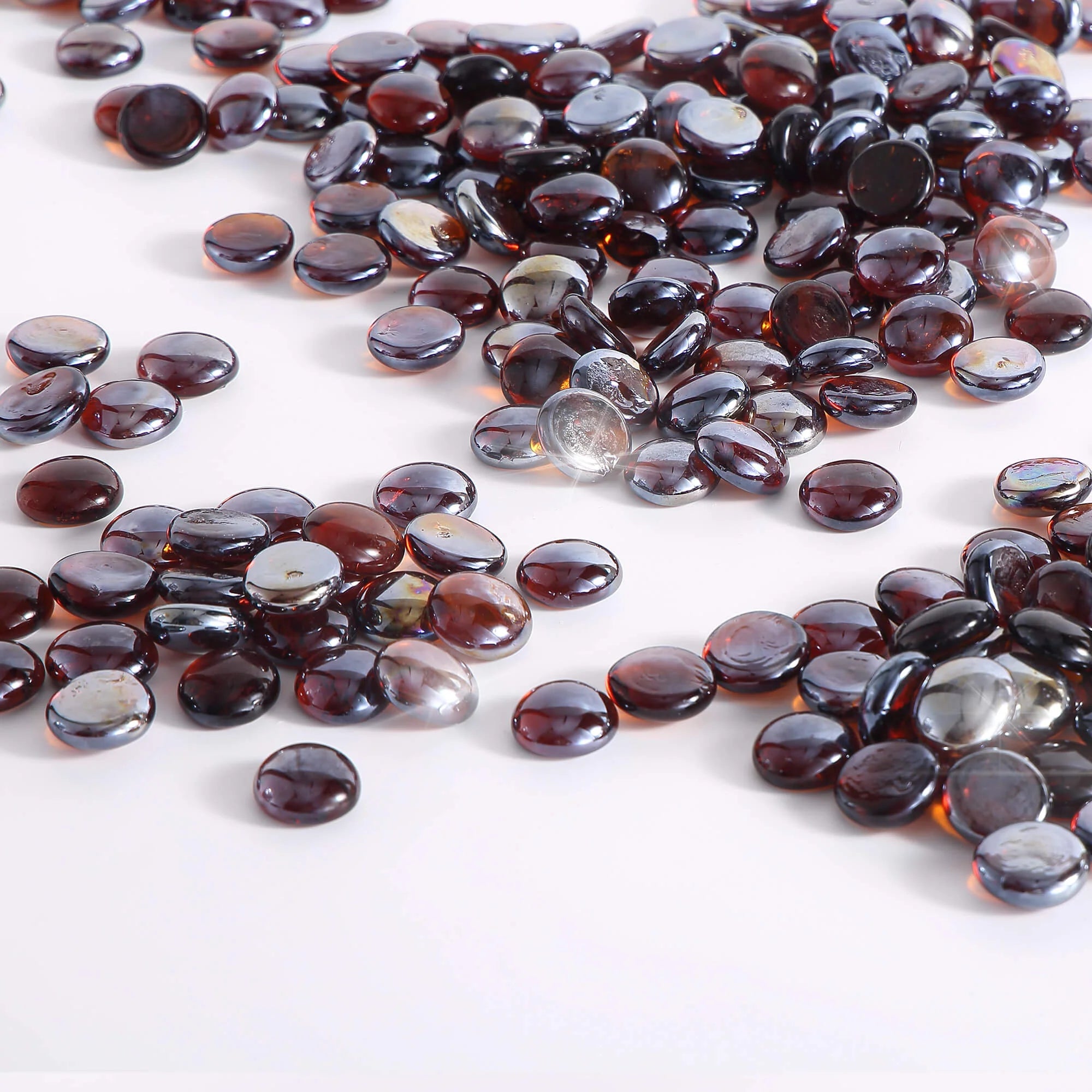 Close-up of amber reflective fire glass beads, dark glossy oval stones