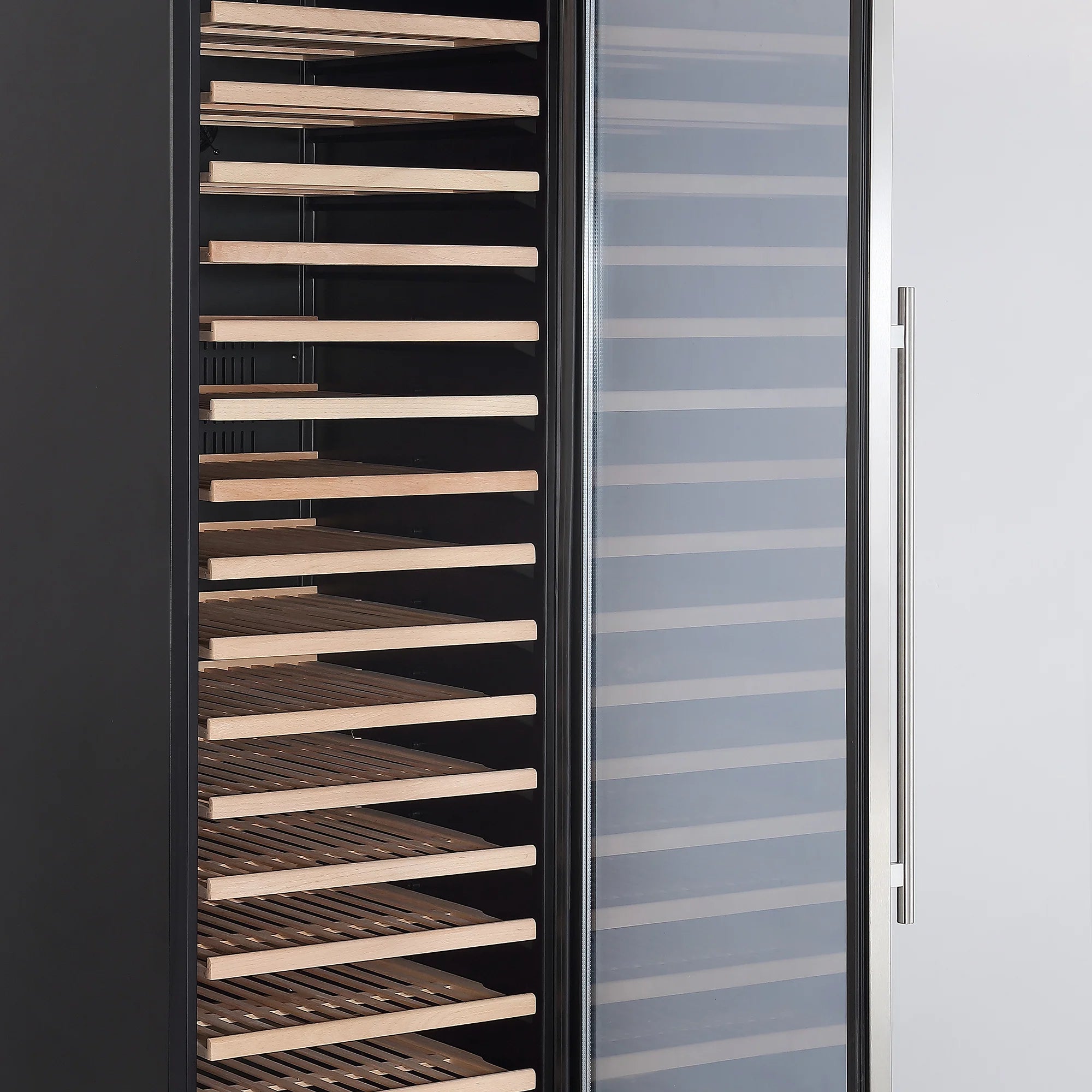 Wine cooler interior with wooden bottle shelves and open glass door