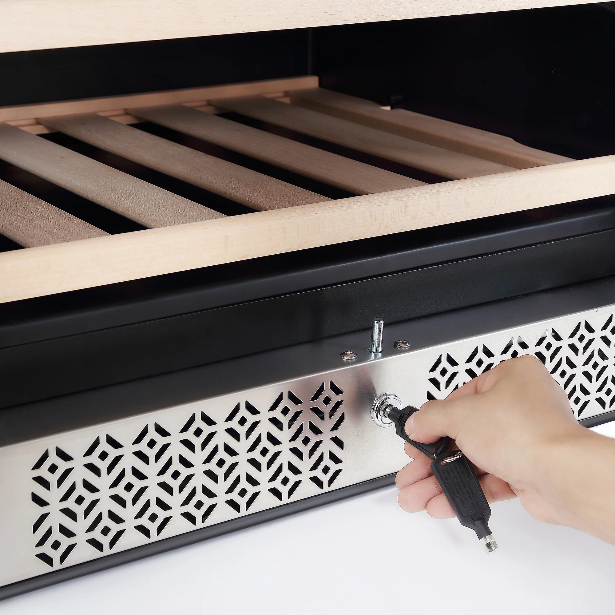 Wine cooler front panel with decorative vent grille and lock with key