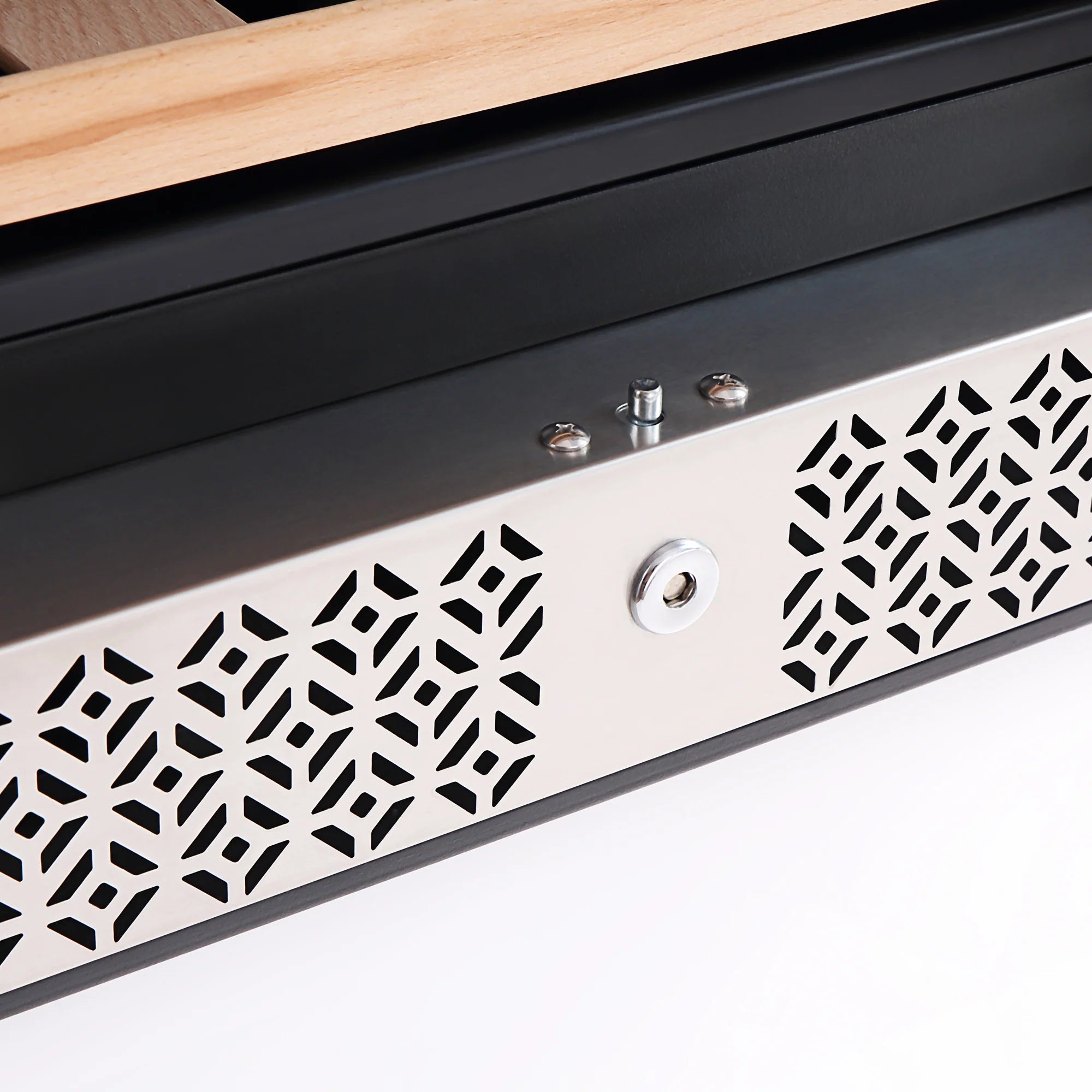 Wine cooler front panel with patterned ventilation grille and metal lock button