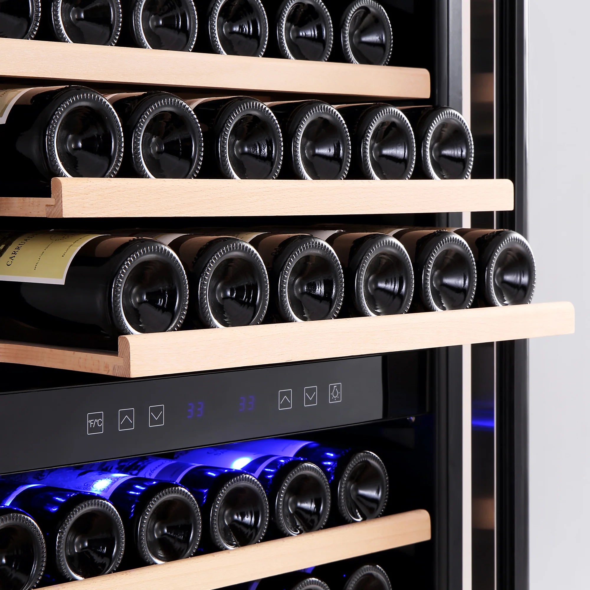 Wine bottles in rows on wooden shelves with blue LED lighting under glass