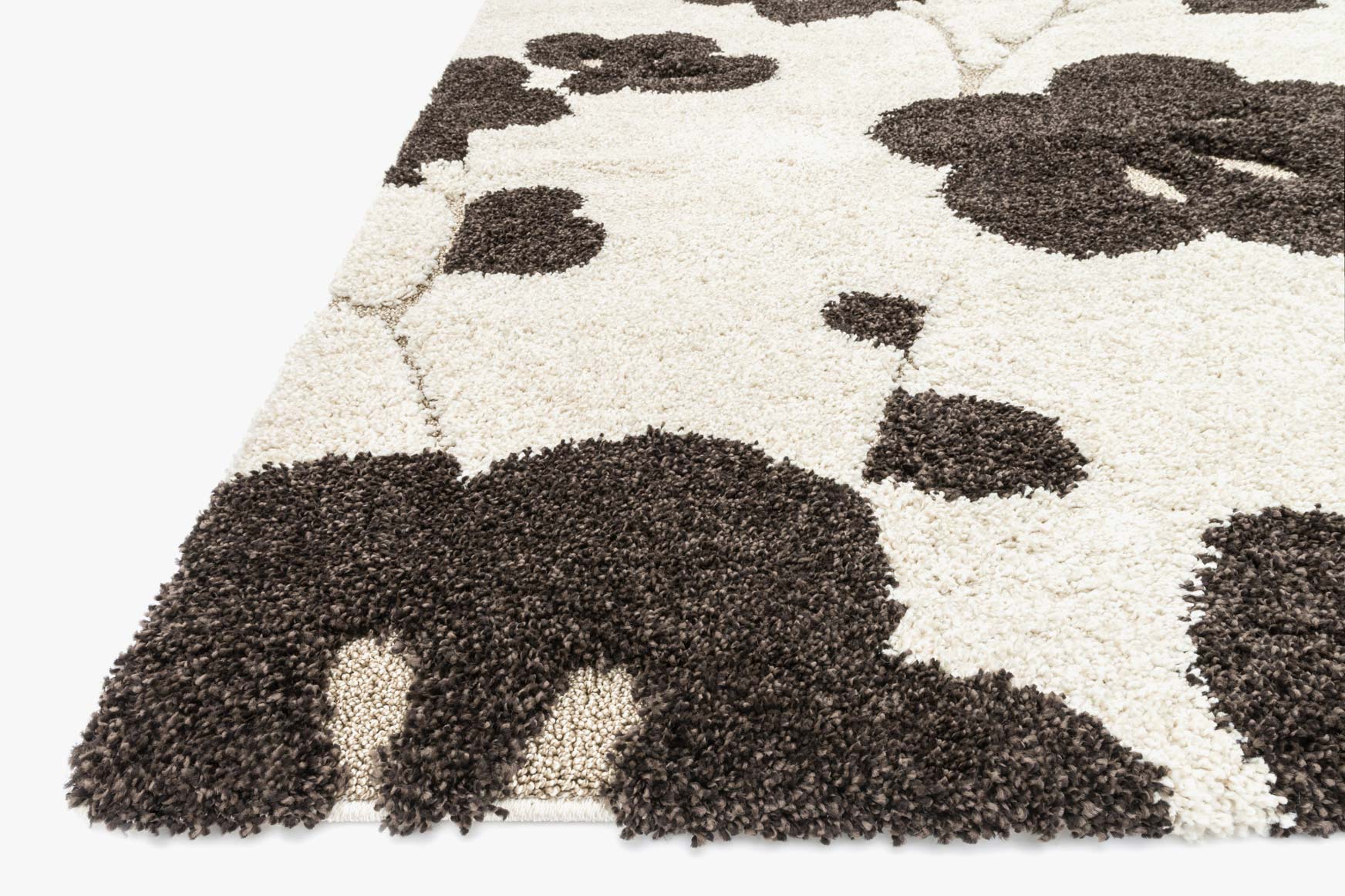 Ivory transitional rug with bold dark brown corner medallions and plush texture