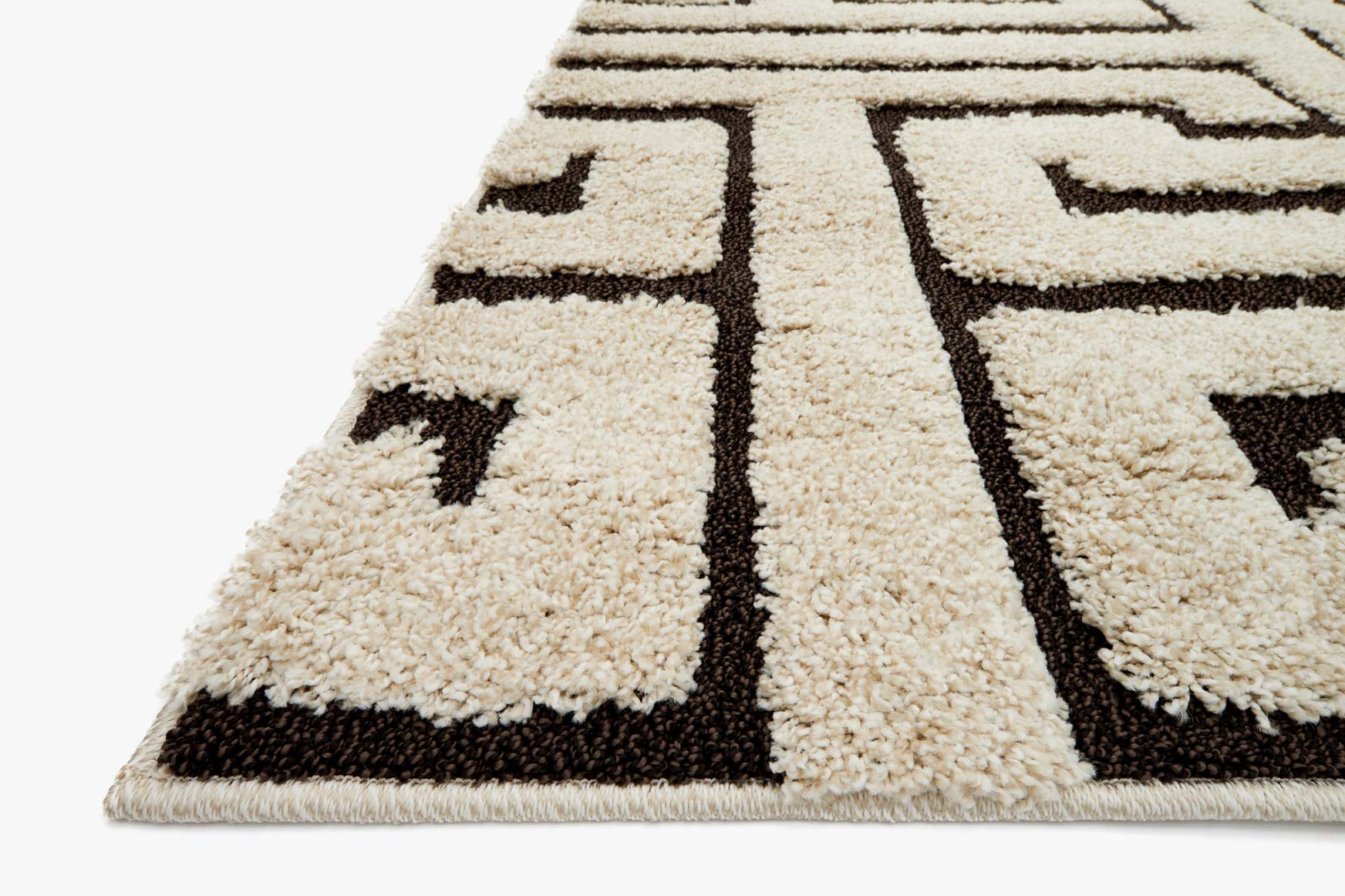 Ivory geometric rug with dark brown border, textured pile, Greek key motif