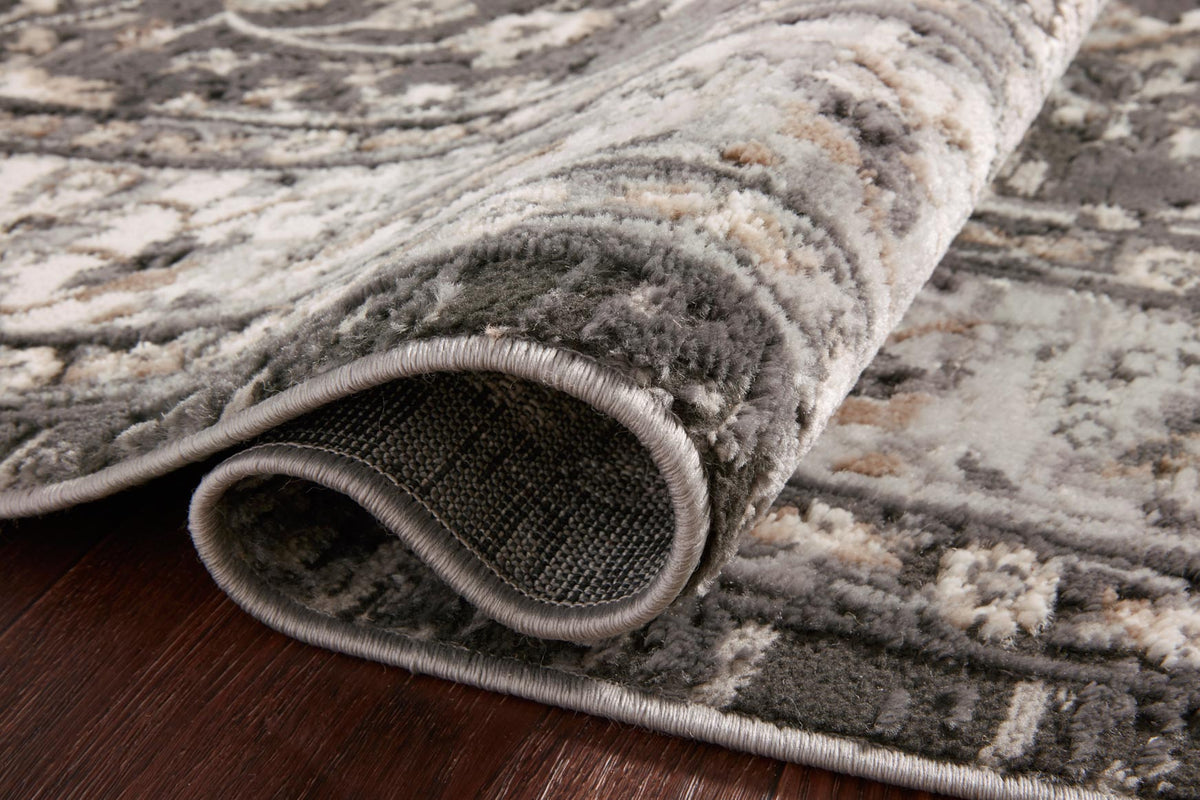 Charcoal and grey rug texture detail with rolled edge and woven backing