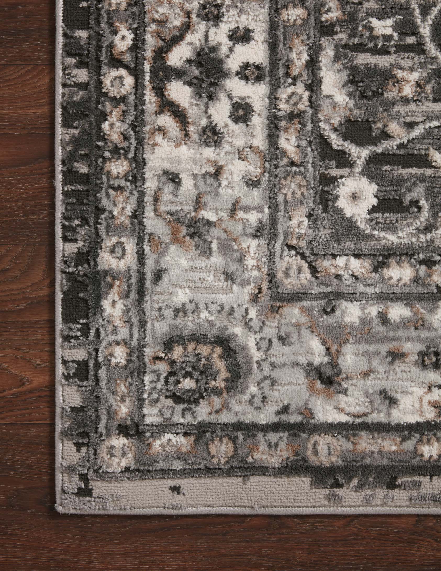 Charcoal and grey rug section with medallion, floral motifs, and distressed overlays