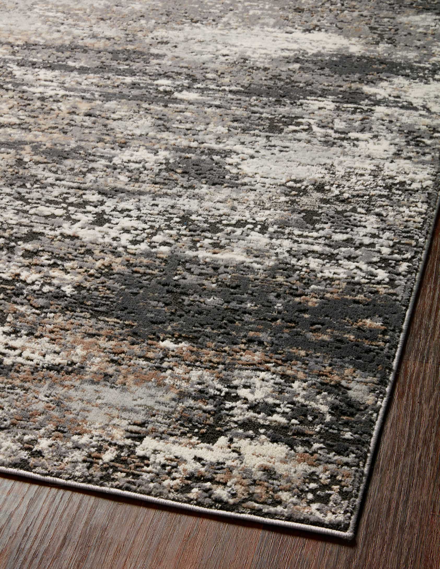 Rectangular charcoal and granite rug with mottled distressed pattern and dark border trim.