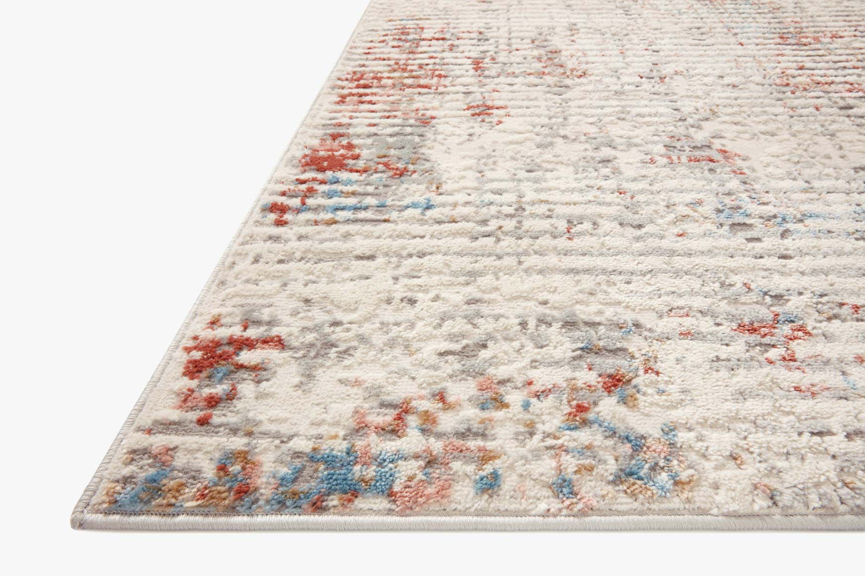 Ivory transitional rug with textured distressed design and red and blue accents along the edge