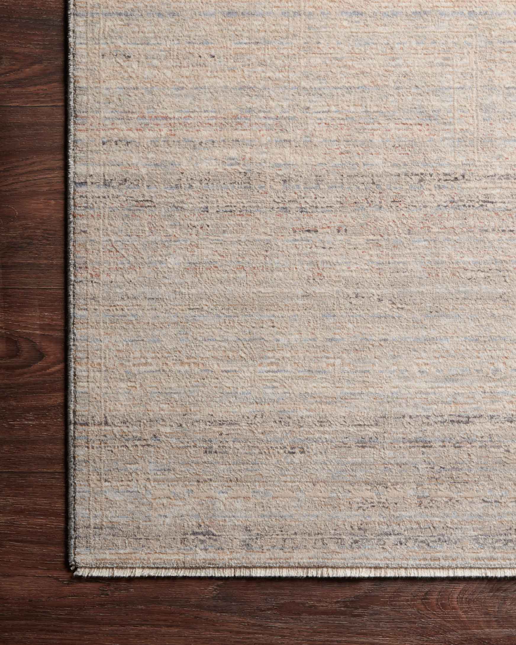 Natural beige rug with muted sky-blue lines and flat woven border edge detail