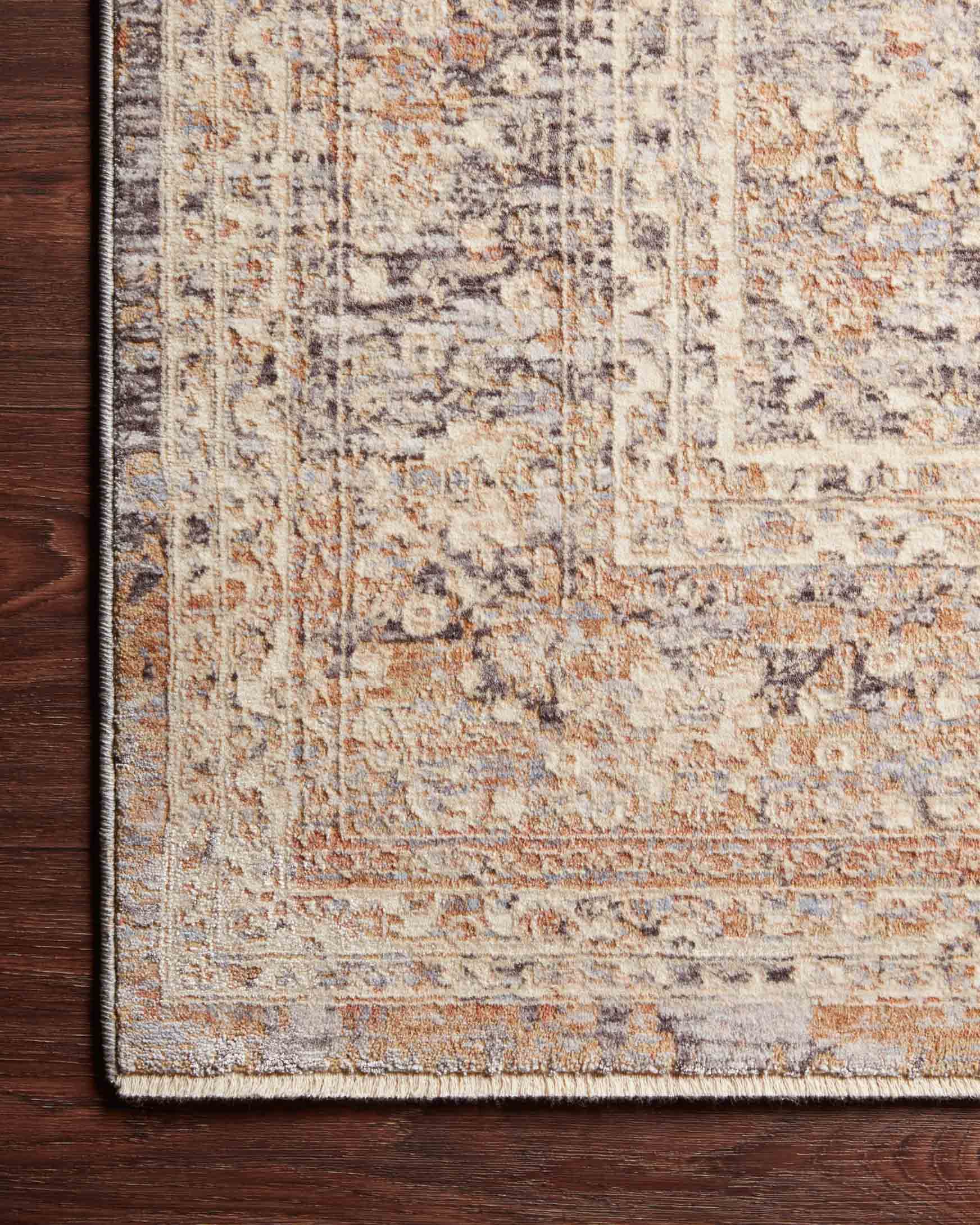 Transitional power-loomed rug corner detail, textured pile with light blue, sand, and gray