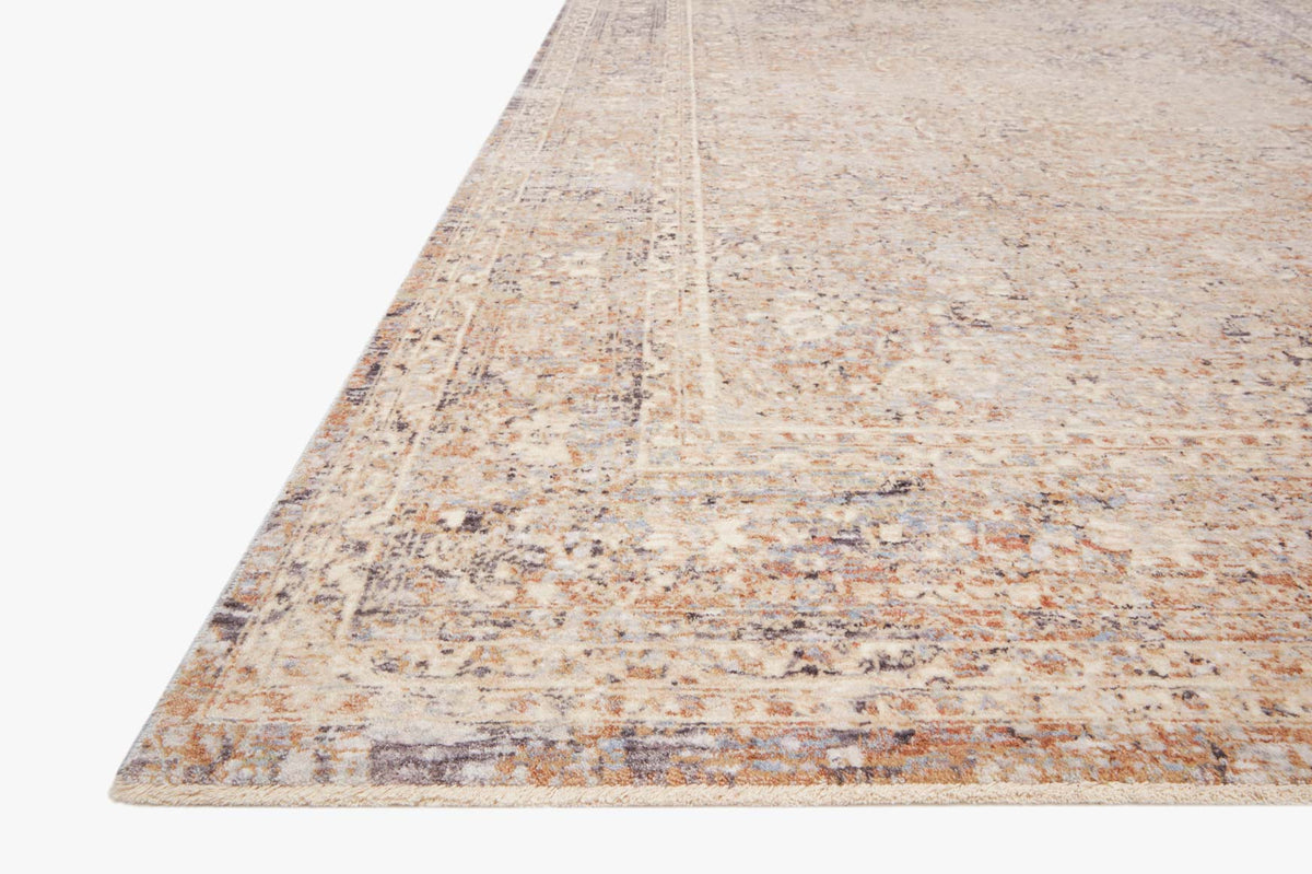 Transitional power-loomed rug in sky and sand tones, angled view, distressed medallion