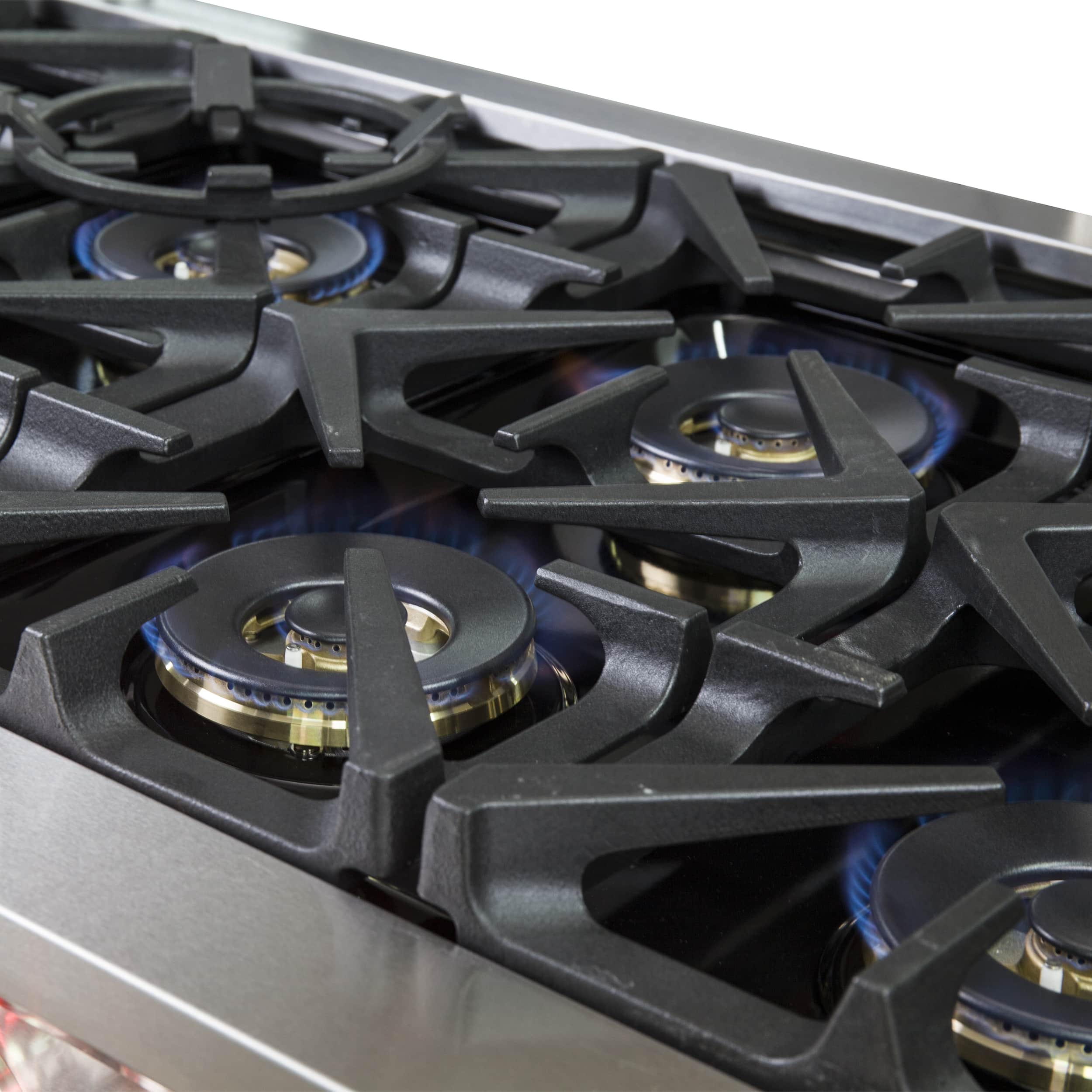 Dual fuel range cooktop with black grates and four gas burner caps