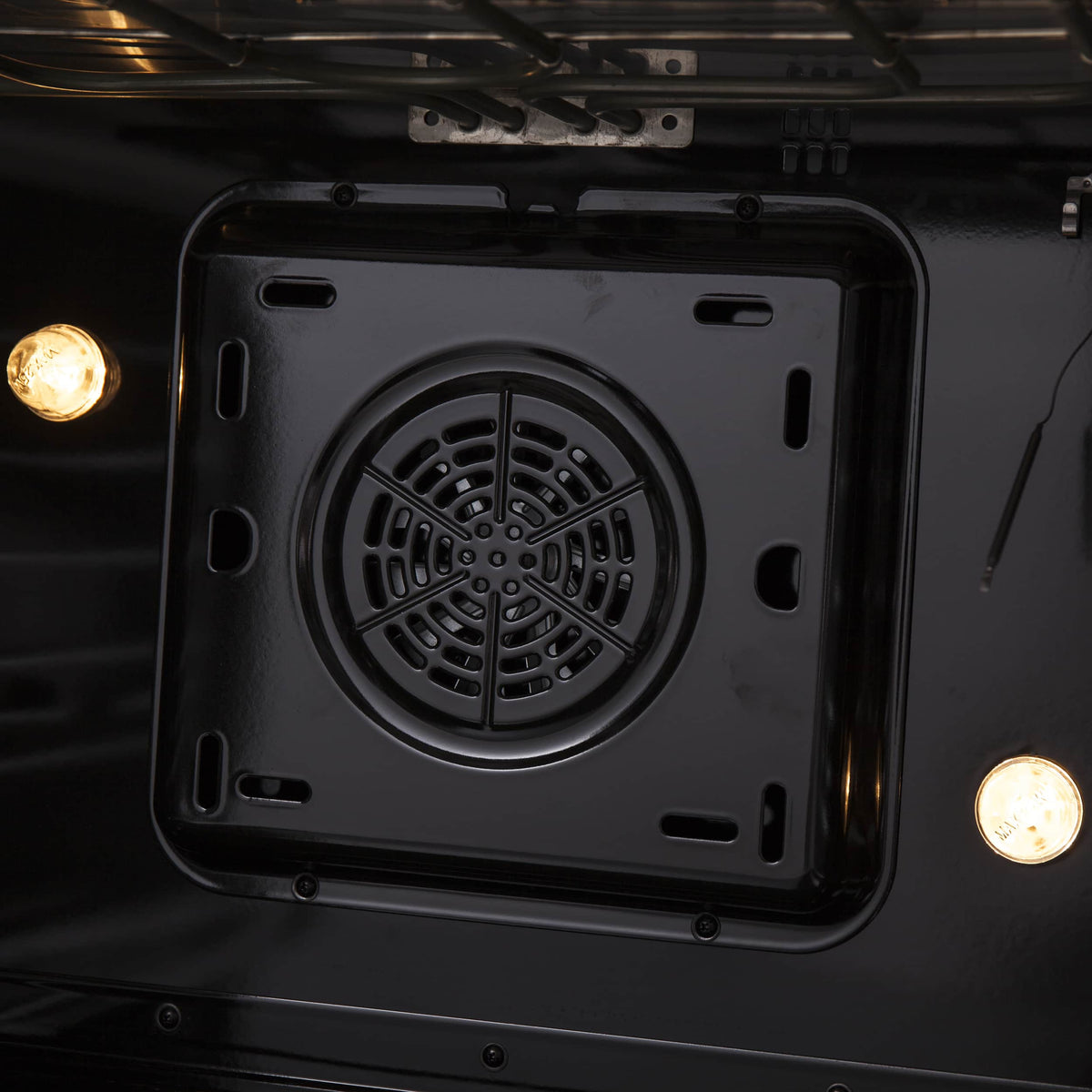 Dual fuel range oven convection fan vent cover, round black grille