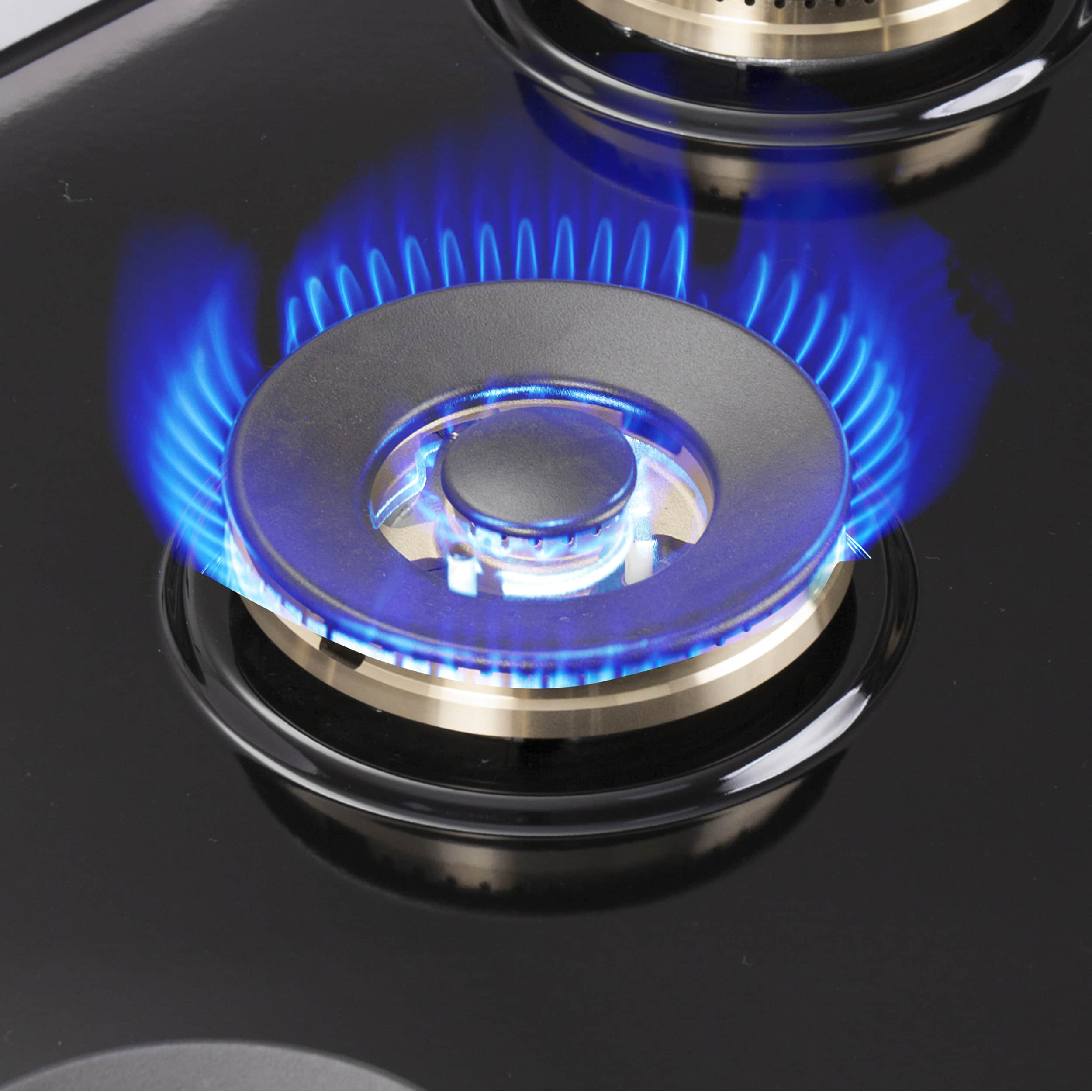 Gas burner with blue flame on stainless cooktop