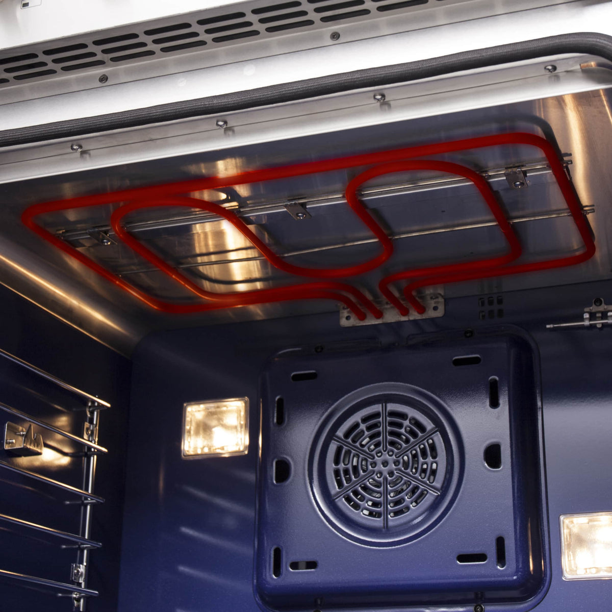 Oven interior showing red broil element above black fan vent and lights