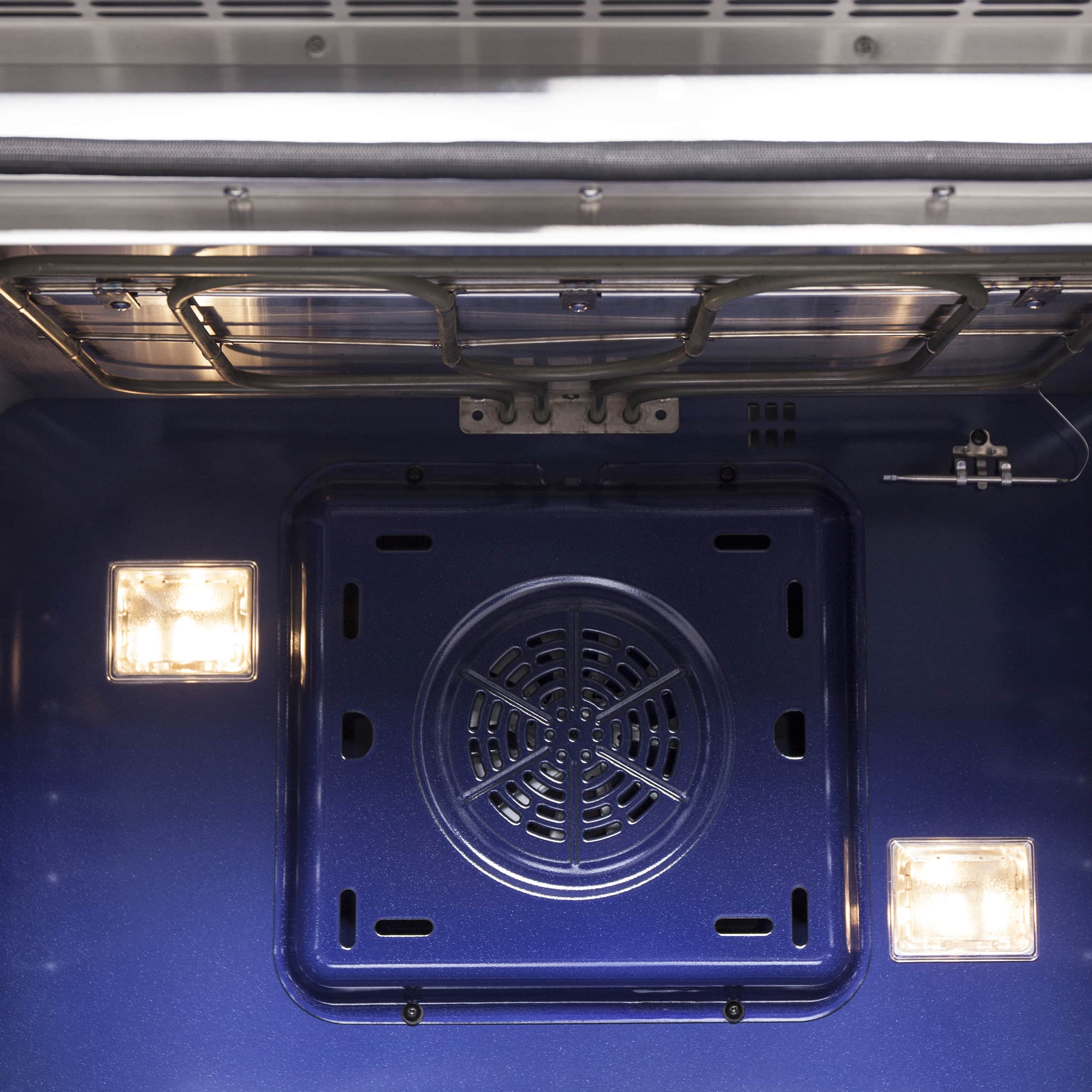Oven interior with black fan vent, glowing light, and rack supports