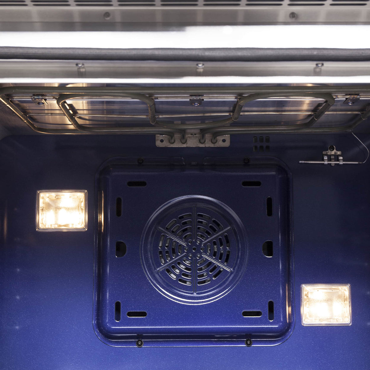Oven interior with black fan vent, side lights, and top heating bar