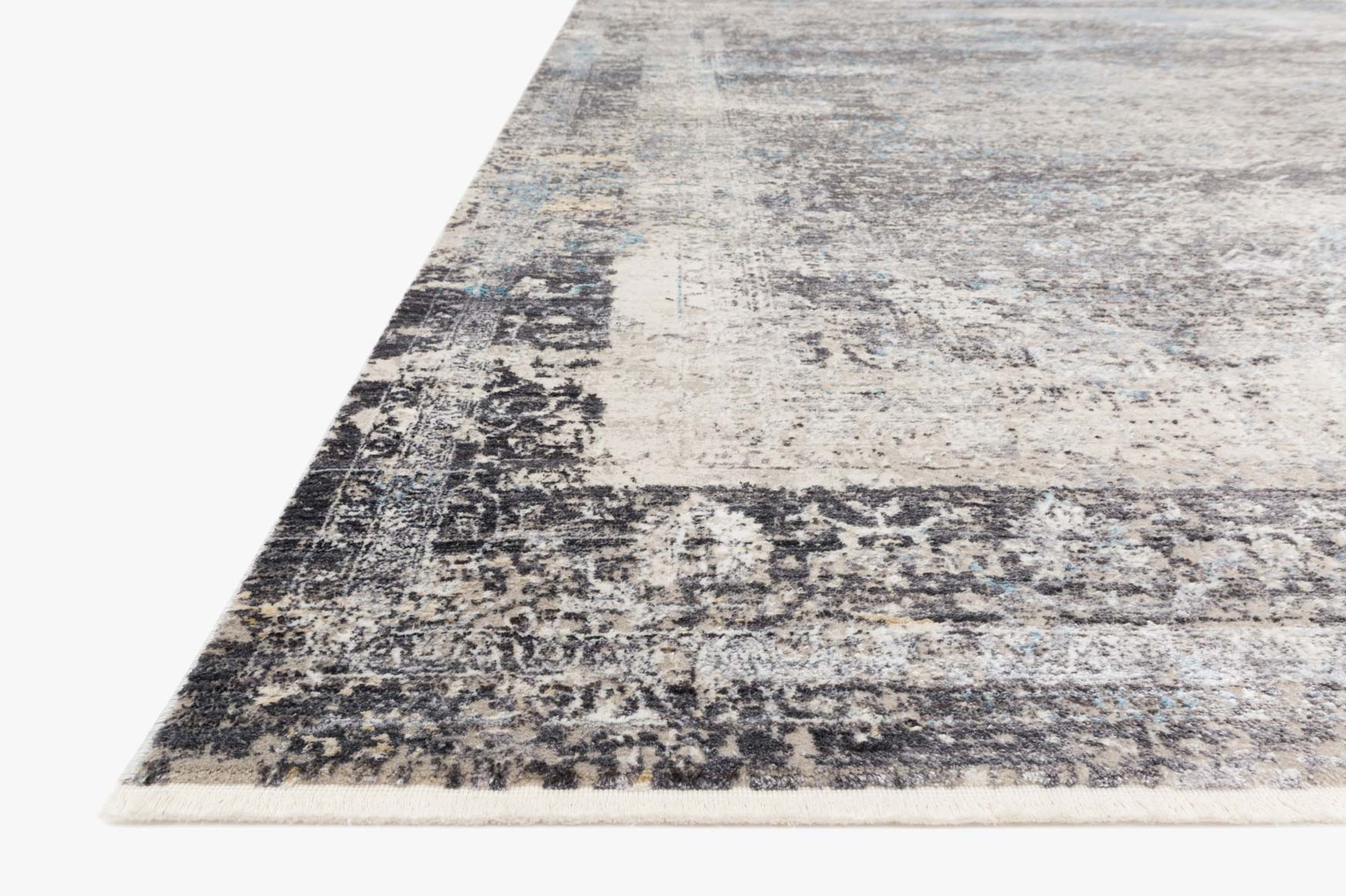 Transitional power-loomed rug corner view, charcoal and sky distressed abstract pattern
