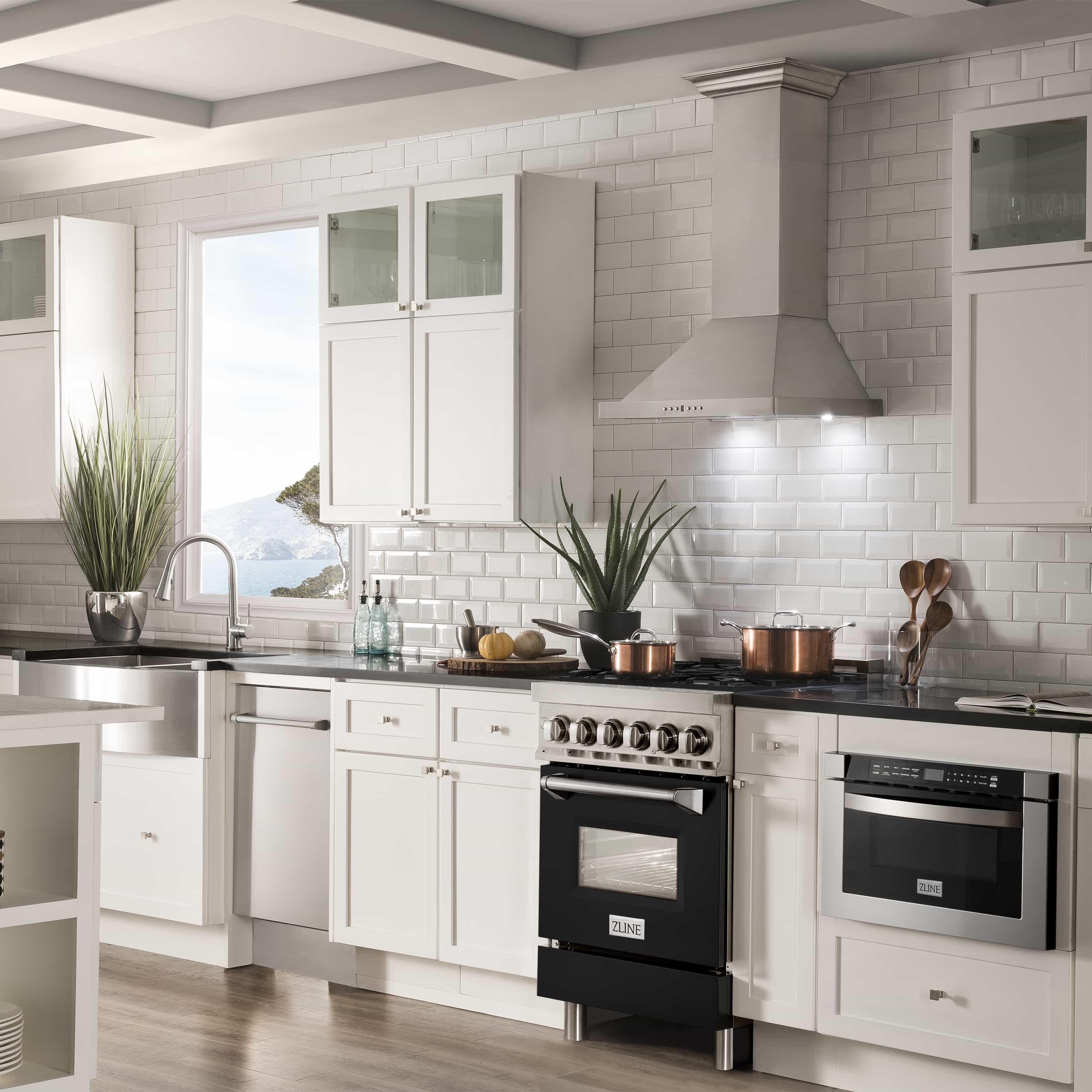 Stainless and black dual fuel range with gas cooktop and electric oven in kitchen