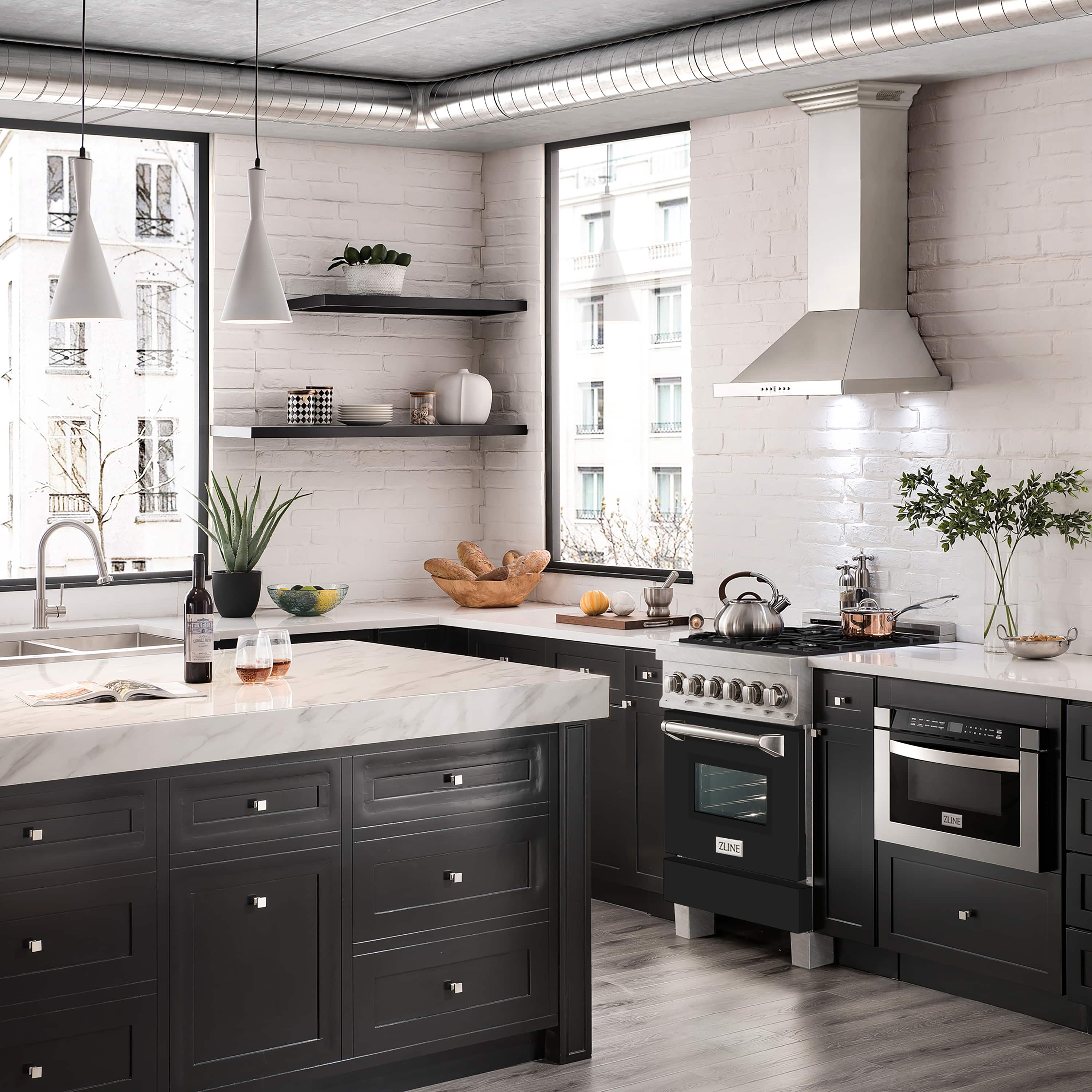 Dual fuel range with satin stainless steel finish, black oven door, and control knobs