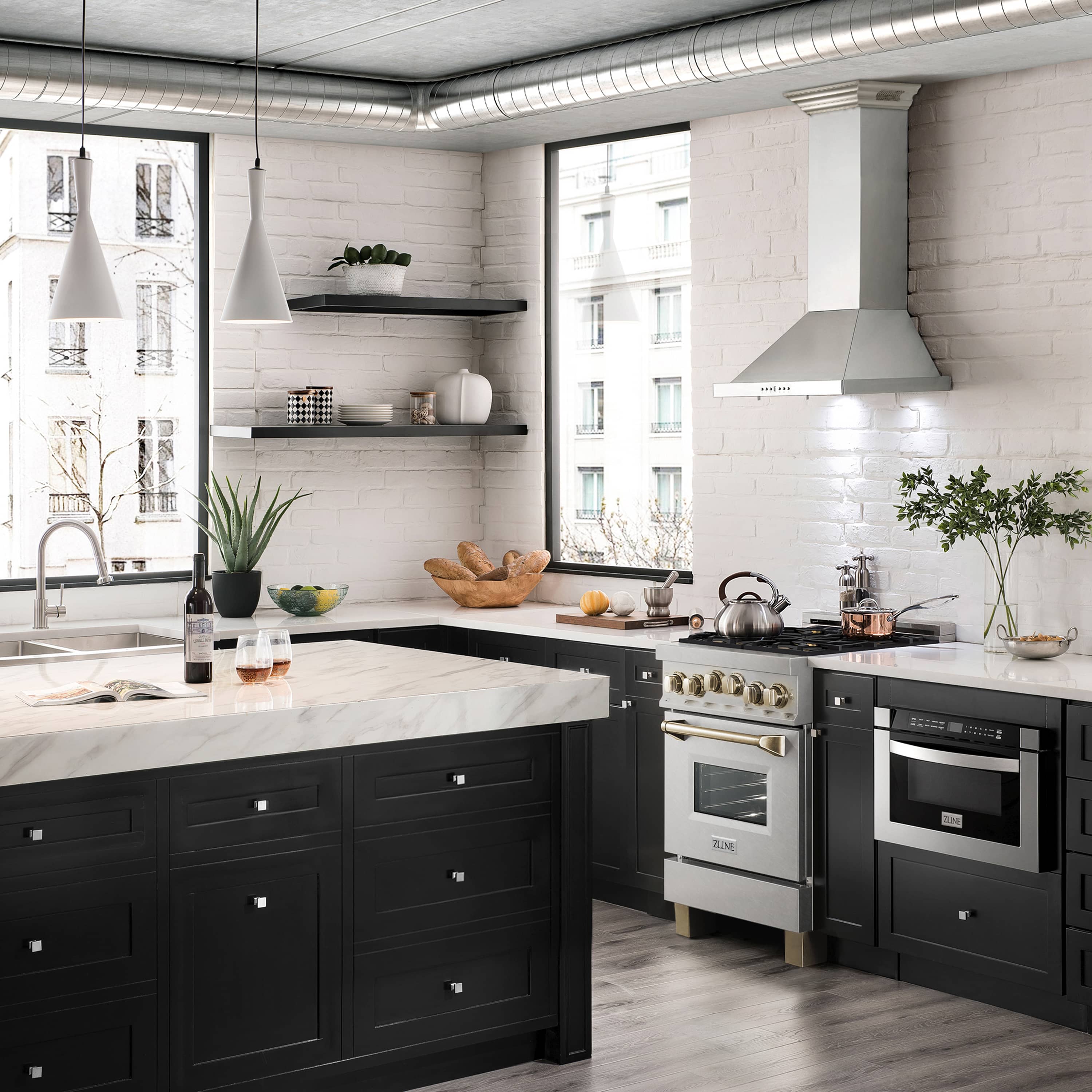 Dual fuel range with satin stainless finish, gold knobs and handles in kitchen setting