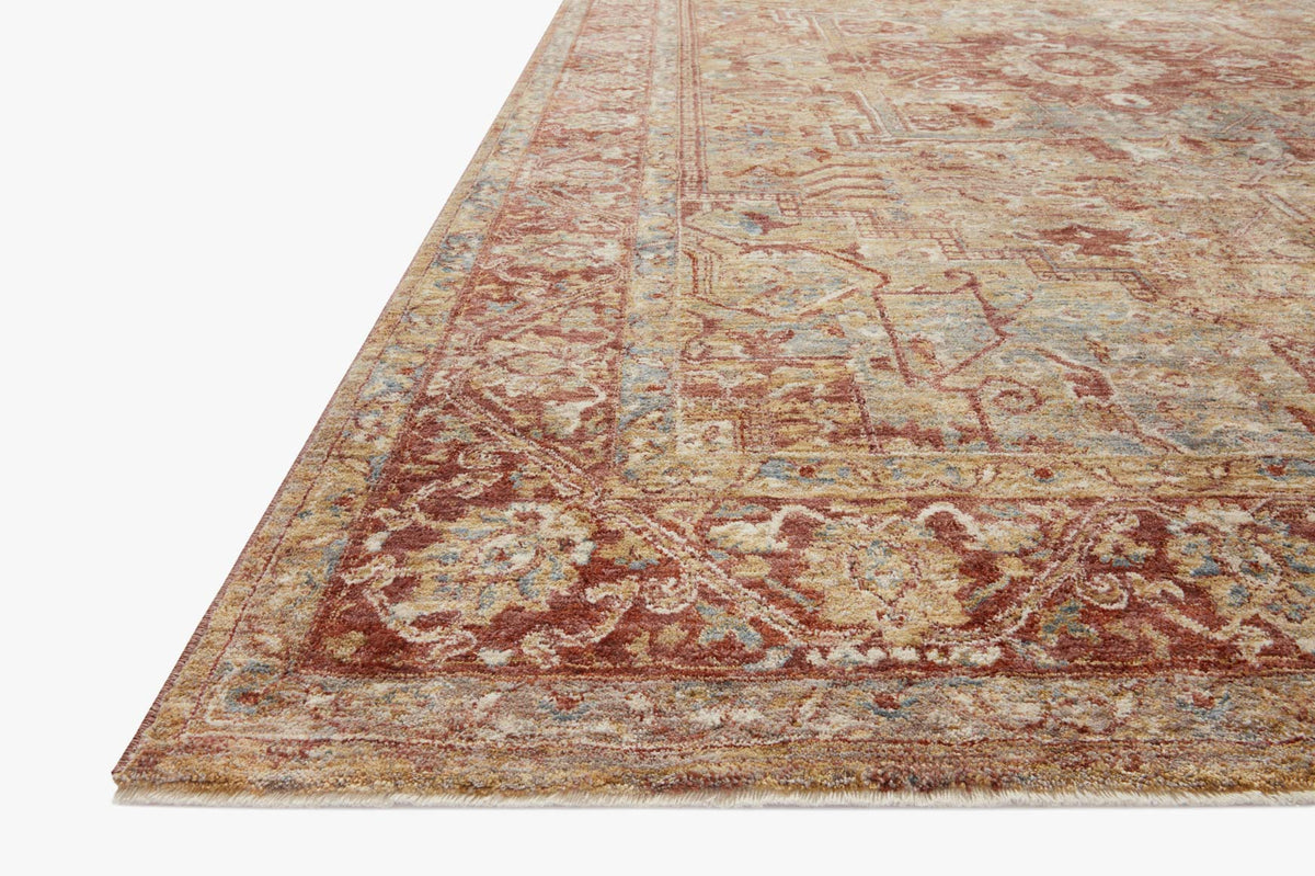 Transitional power-loomed rug corner showing distressed gold and brick ornate design