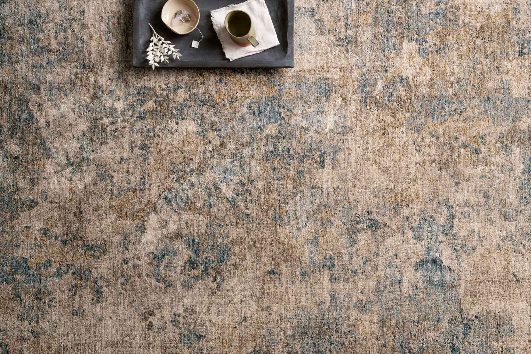 Taupe and denim power-loomed rug with distressed speckled abstract design