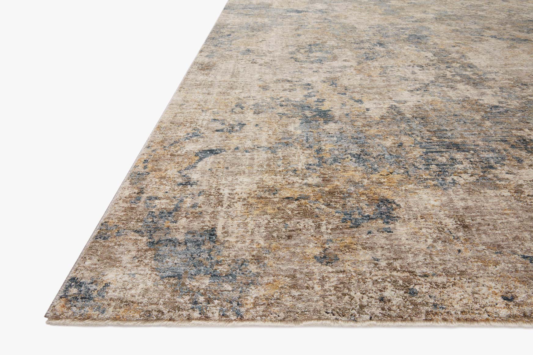 Taupe and denim power-loomed rug corner view with distressed abstract pattern