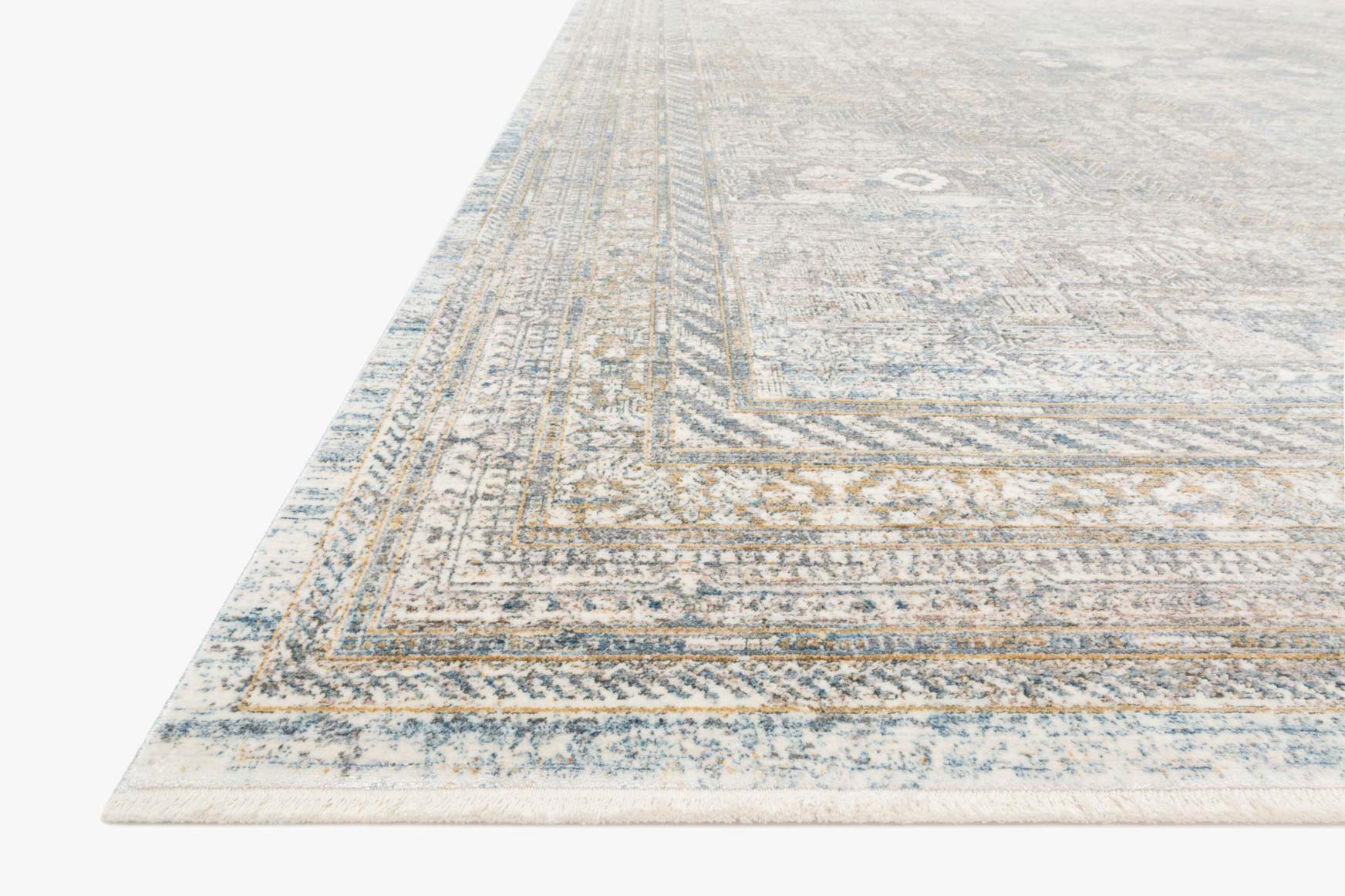 Corner view of traditional power-loomed rug with light blue striped banding