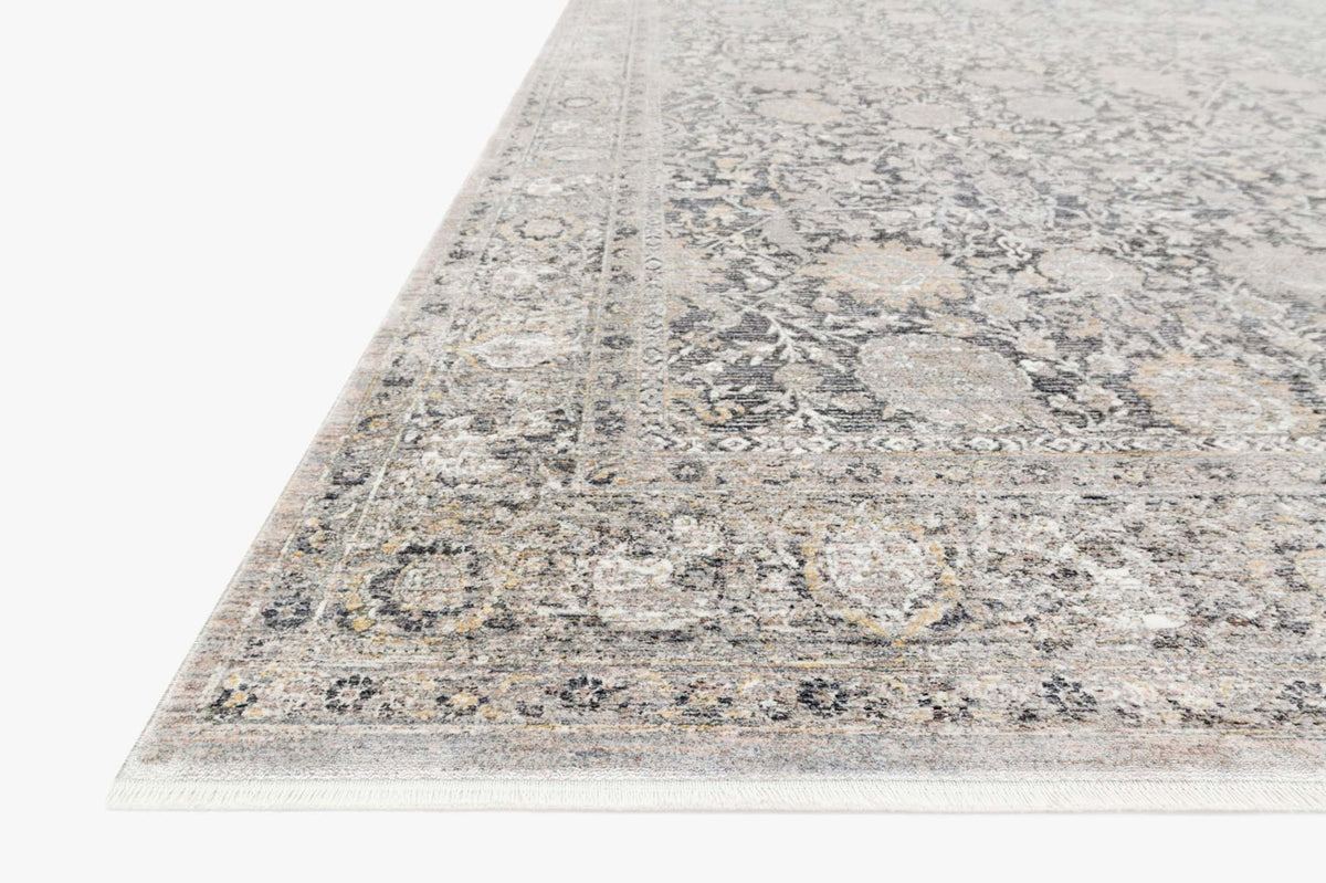 Charcoal and sand traditional rug corner with distressed border and geometric motifs