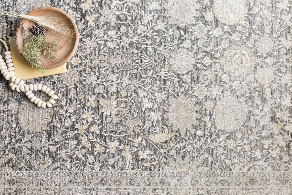 Charcoal and sand rug detail with ornate medallion and floral motifs