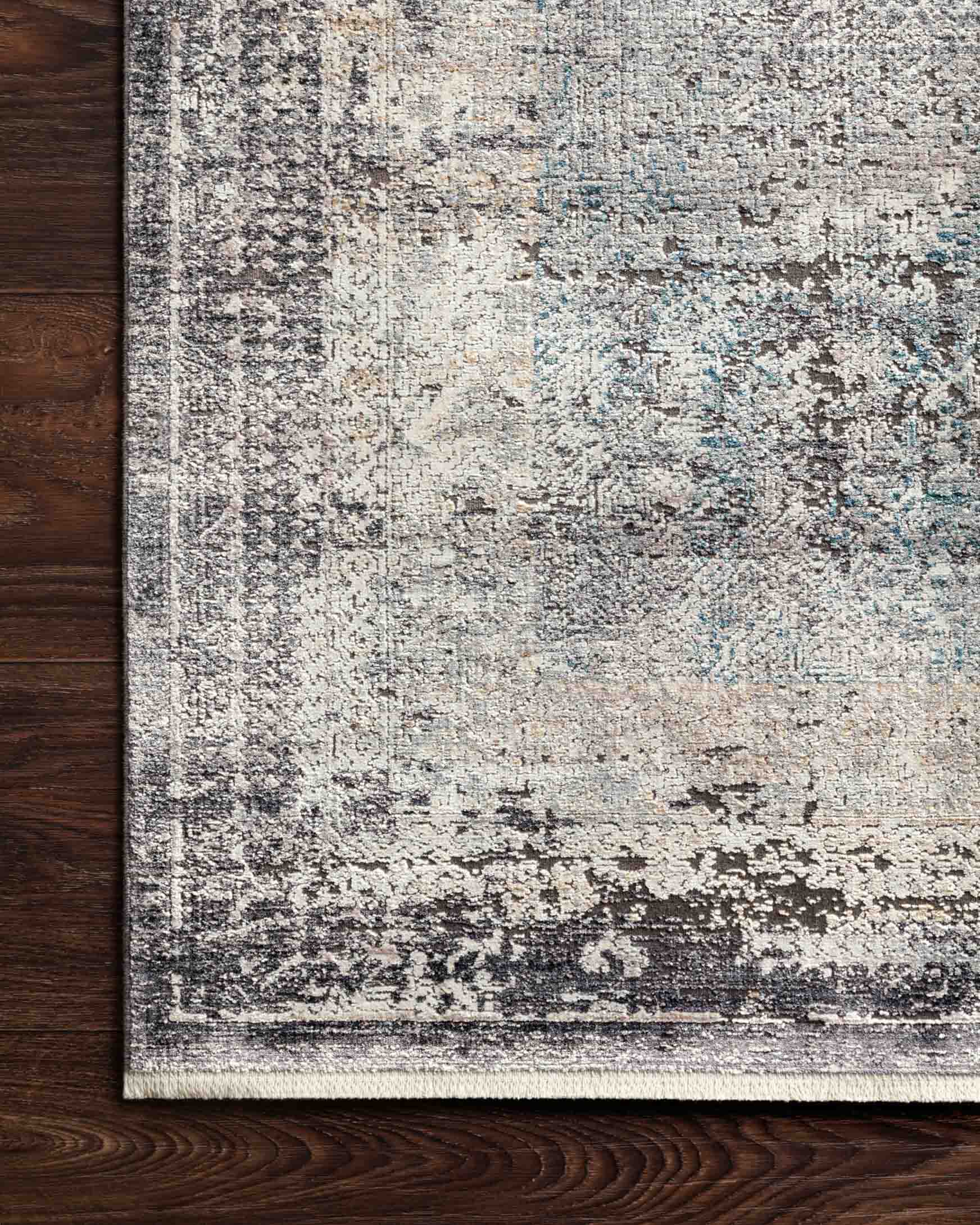 Traditional power-loomed rug with distressed grey, blue highlights and charcoal border detail.