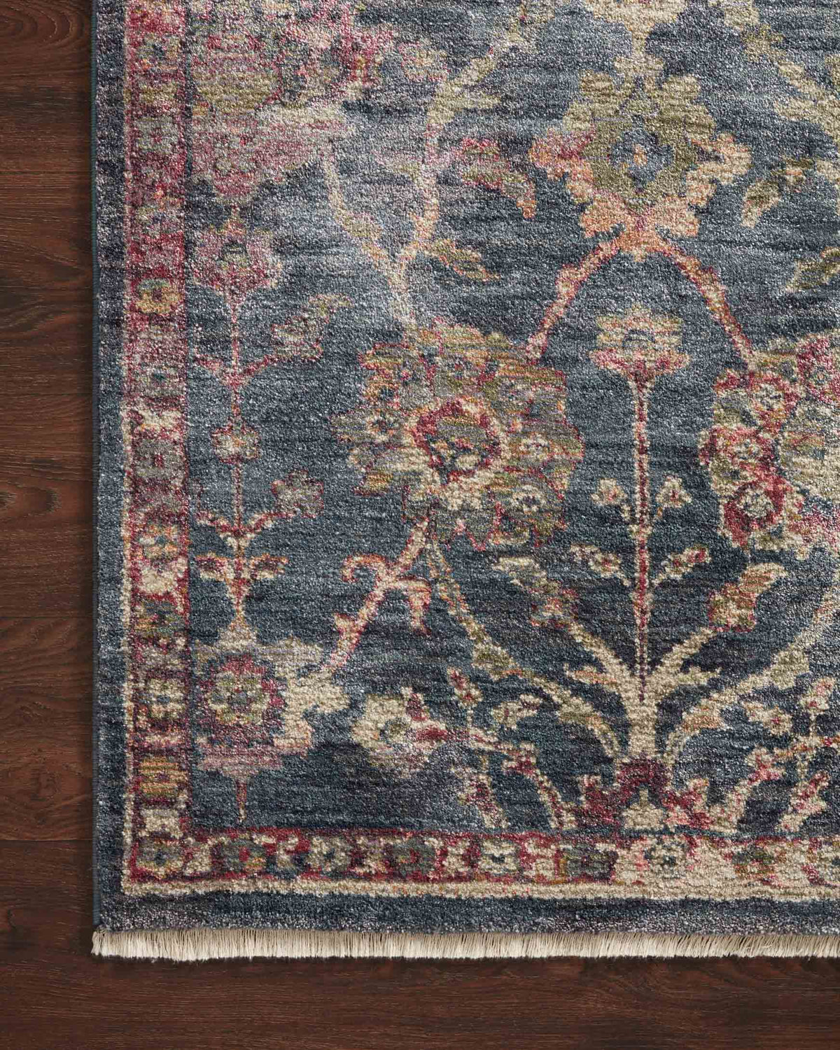 Close-up of navy traditional power-loomed rug with floral motifs and multicolor highlights