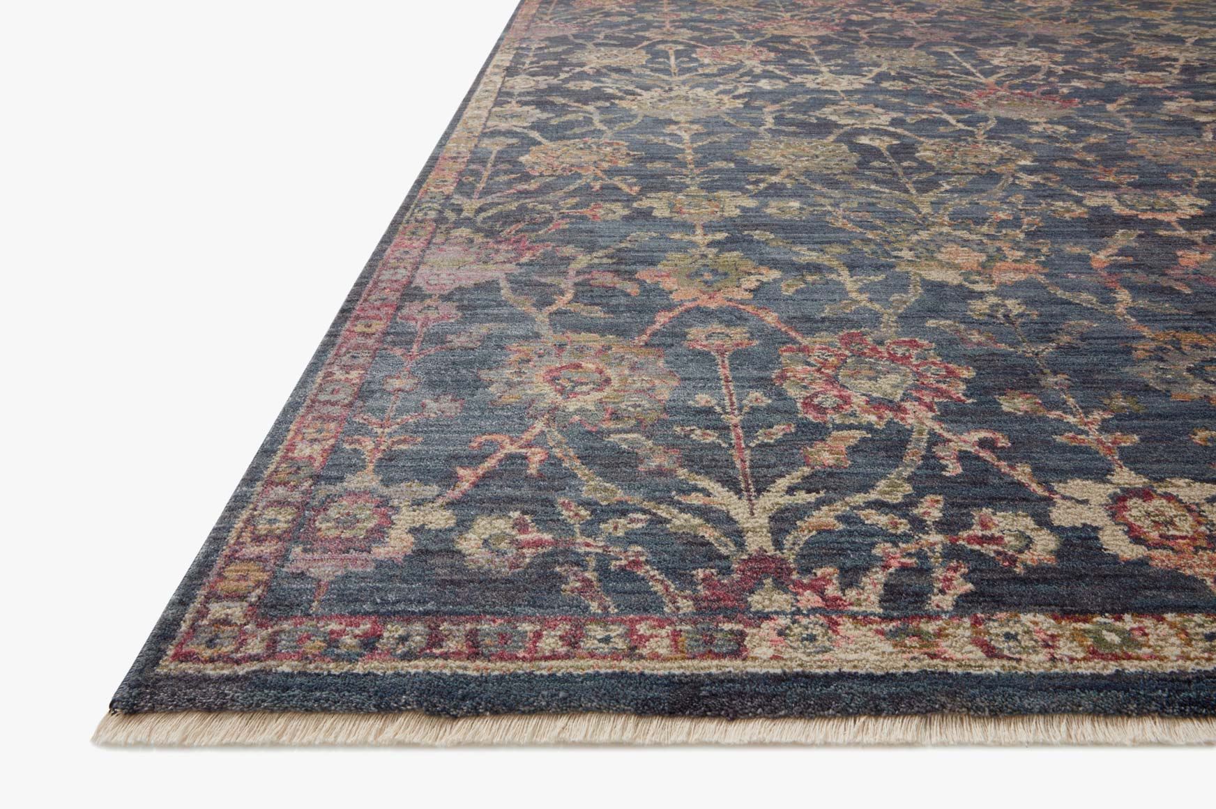 Corner view of navy traditional power-loomed rug with red and tan floral details