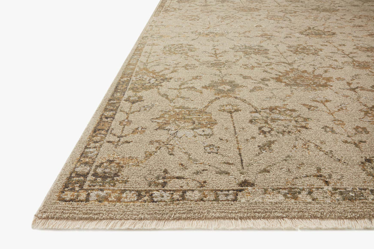 Corner view of rectangular rug with fading floral vines pattern in silver sage and tan
