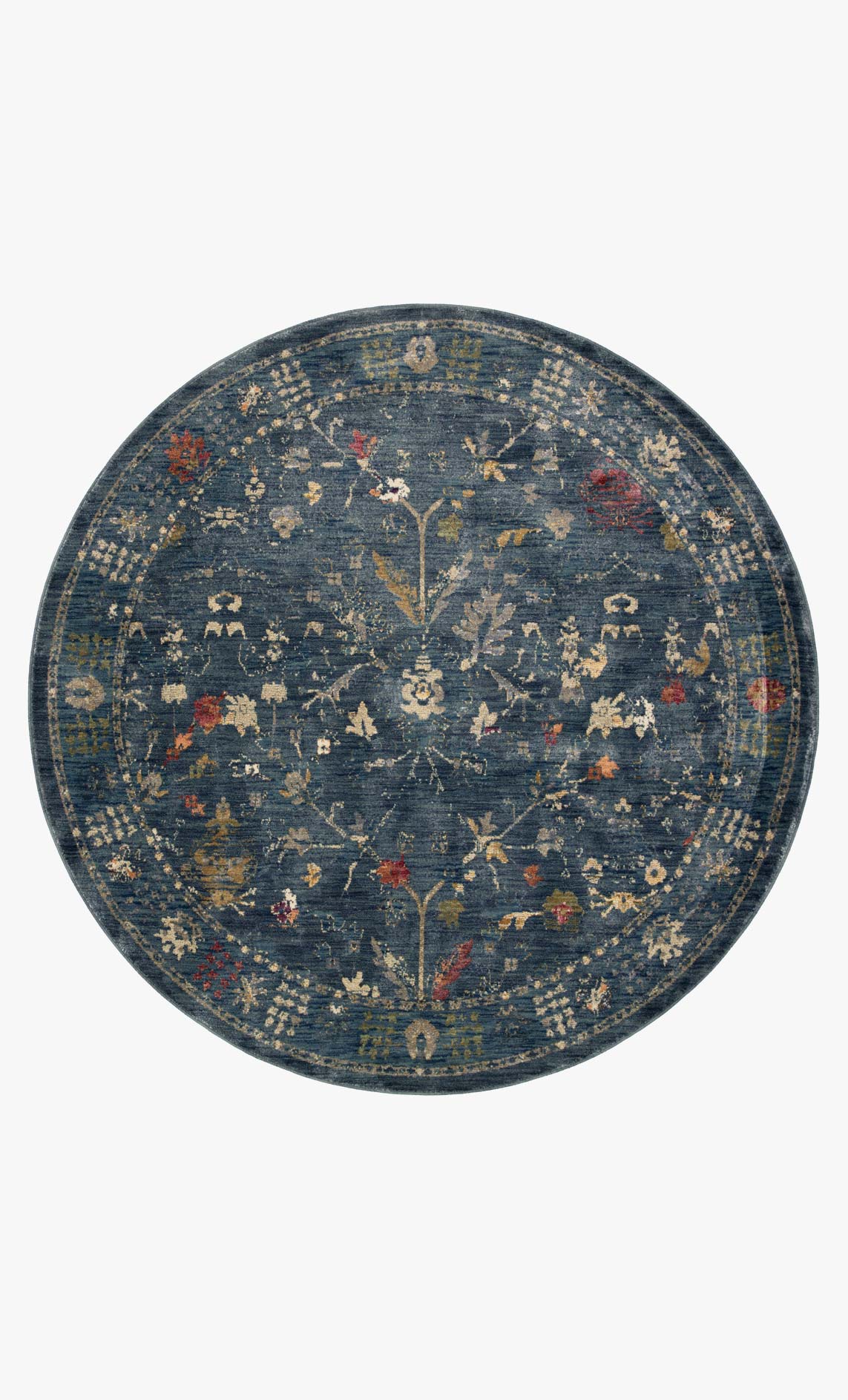 Round denim blue rug with ornate distressed pattern and multicolor accents