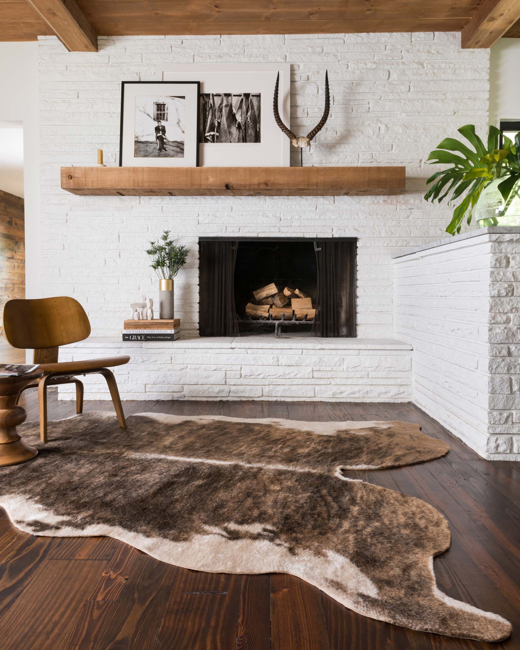 Camel and beige cowhide-style area rug with irregular hide pattern on wood floor