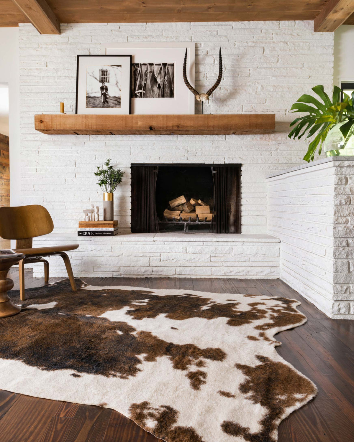 Beige and brown cowhide-style rug with irregular spots, corner view