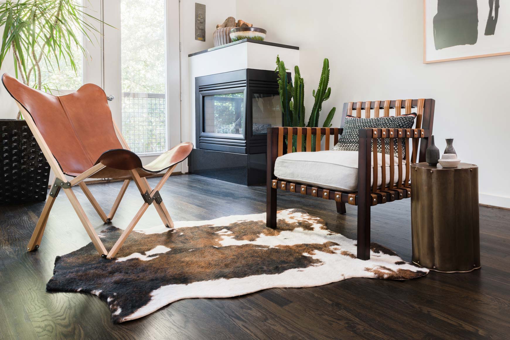 Beige and brown cowhide-style rug with irregular spots, wide corner view