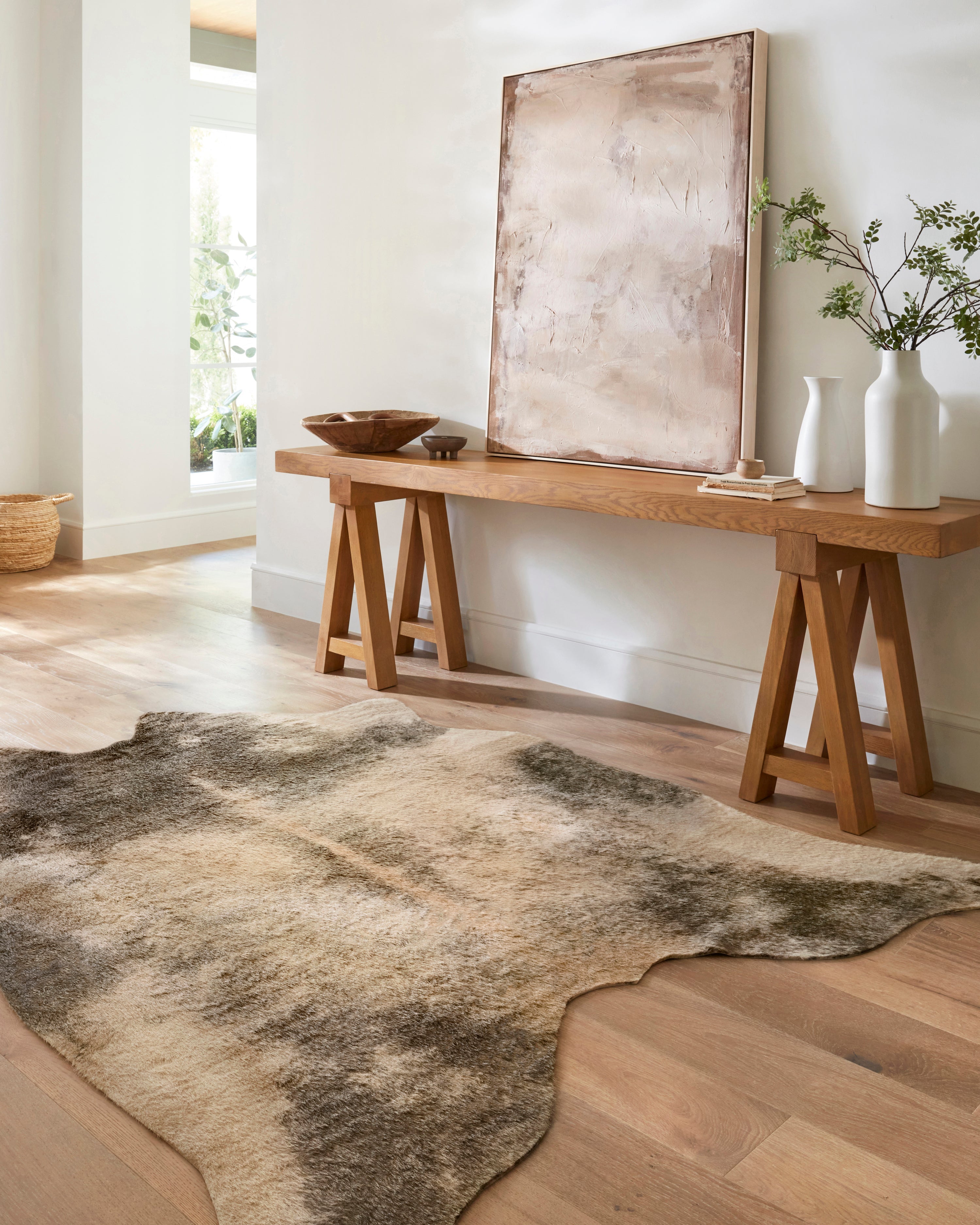 Beige and ash power-loomed area rug with mottled pattern and hide-shaped edges